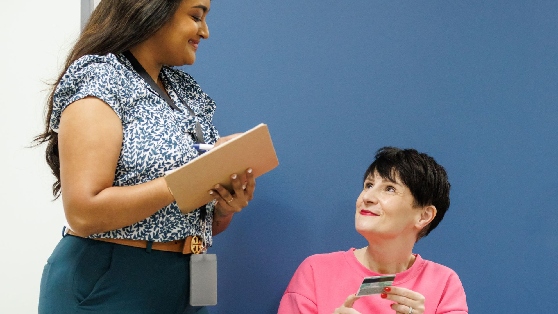 Someone shows a health administrator their health card.