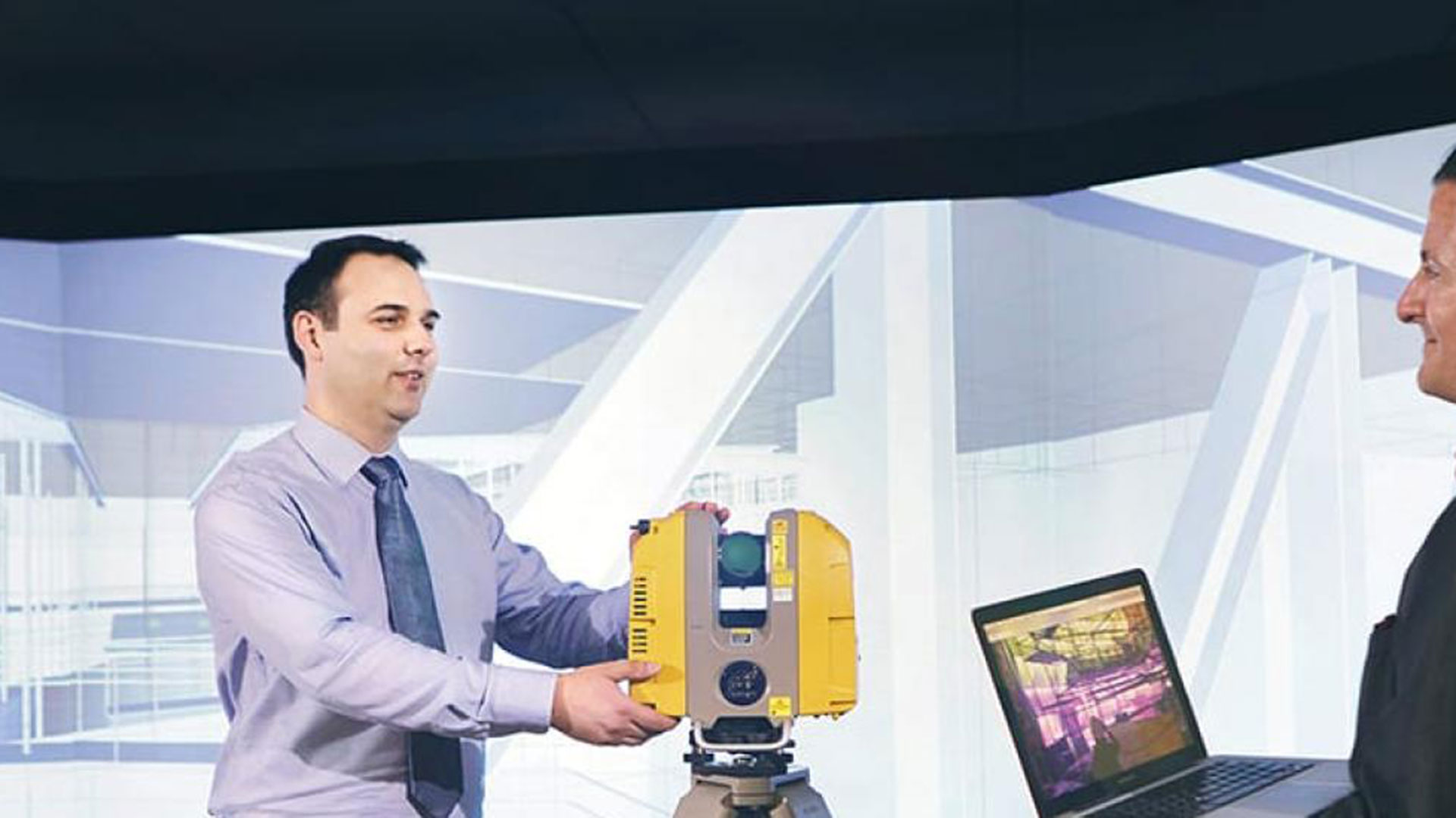 Teacher demonstrating BIM equipment and technology to a student