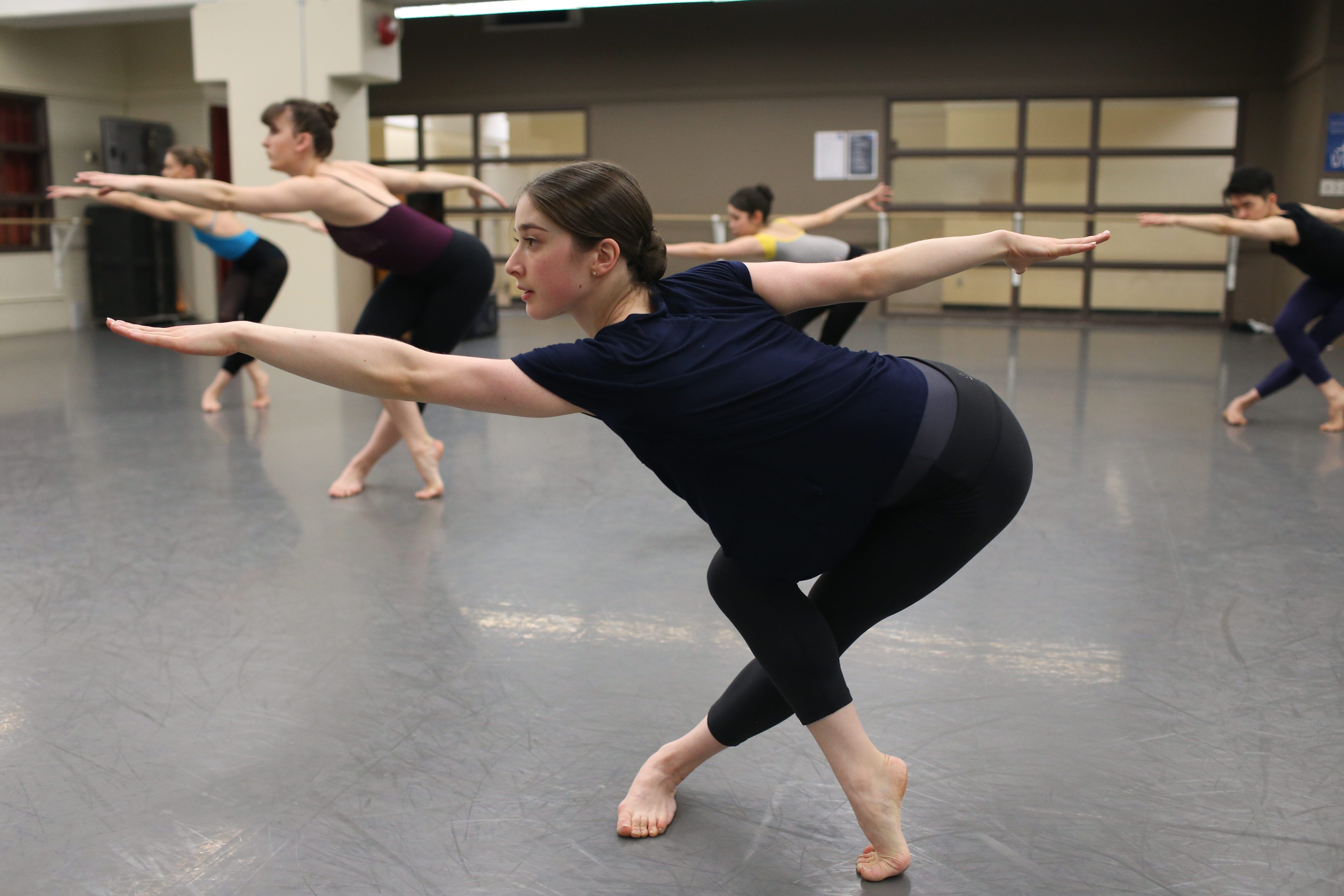 Students practicing dance during a class in a studio