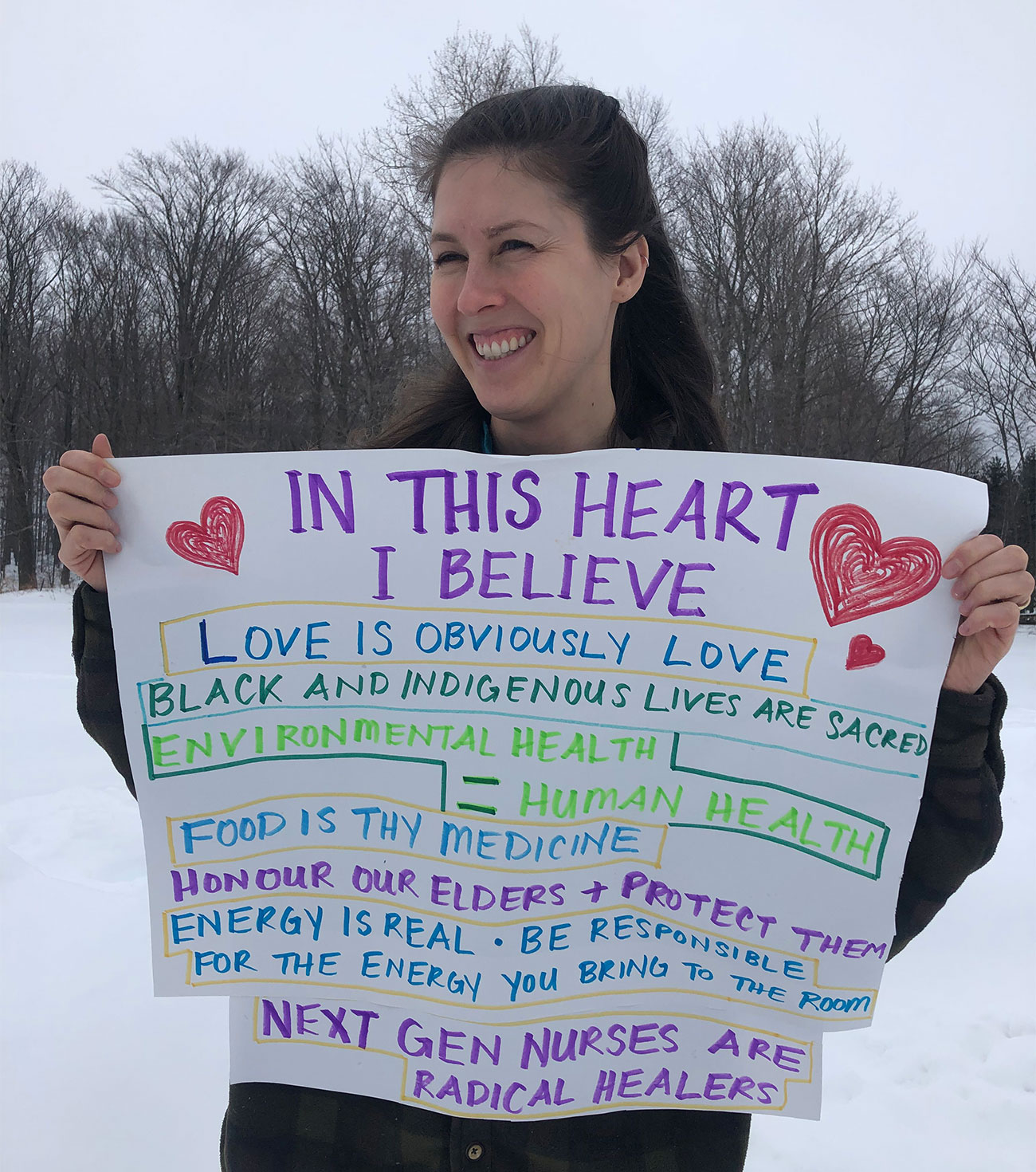 Nursing student Breanne Drennan holding hand-written sign