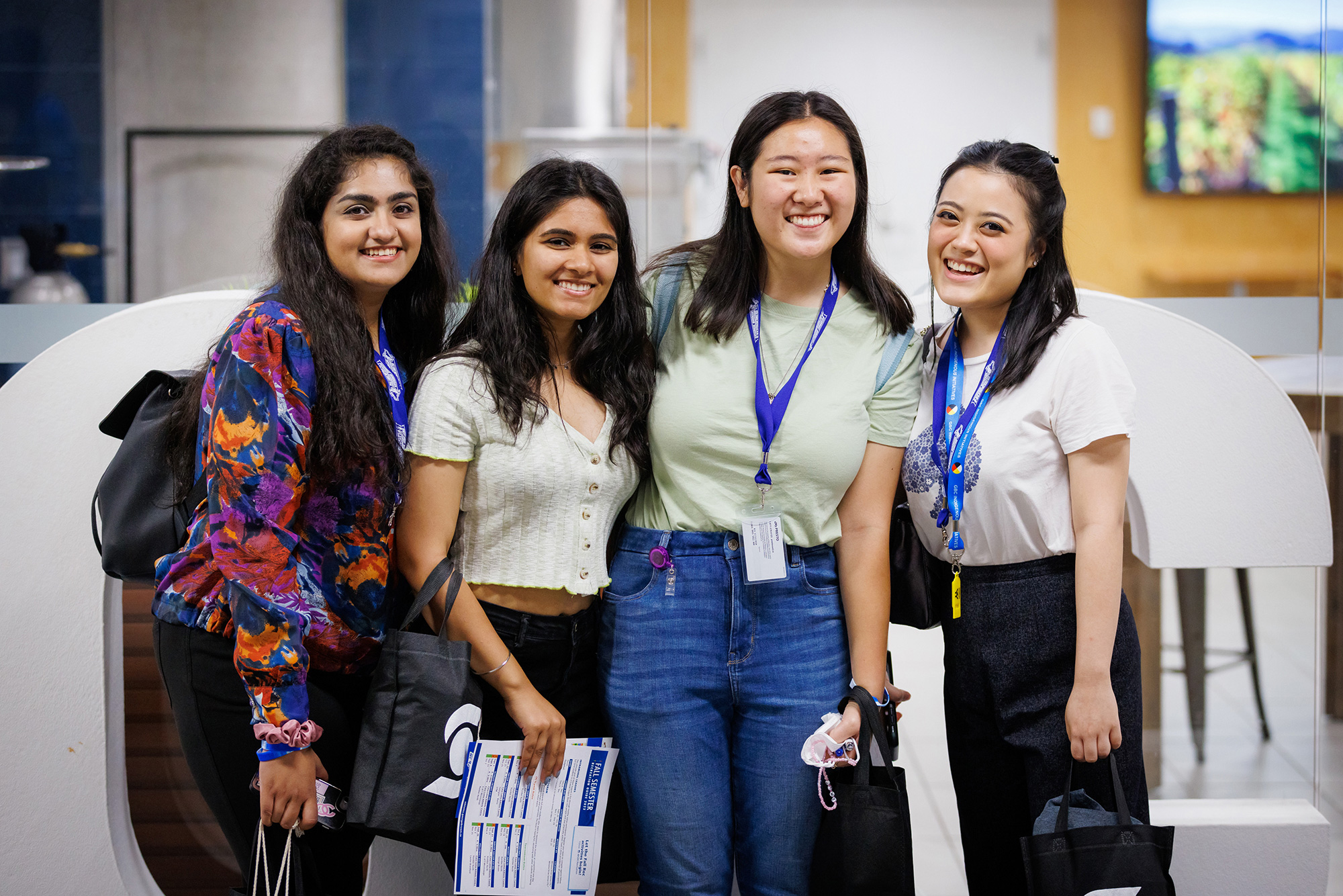 Four students stand posing together