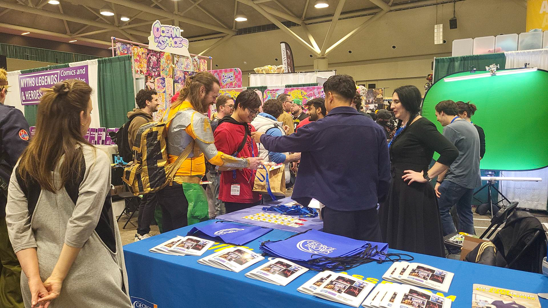 A group of visitors in costume stop by the media and performing arts booth at Toronto Comicon
