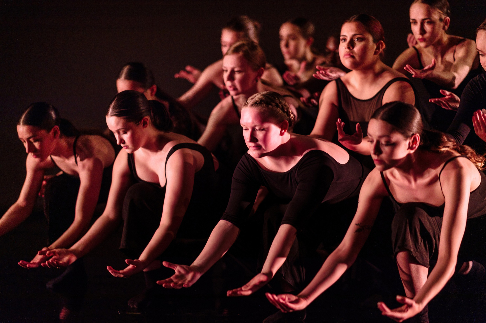 Student dancers in a production of Unleashed pose with arms outstretched