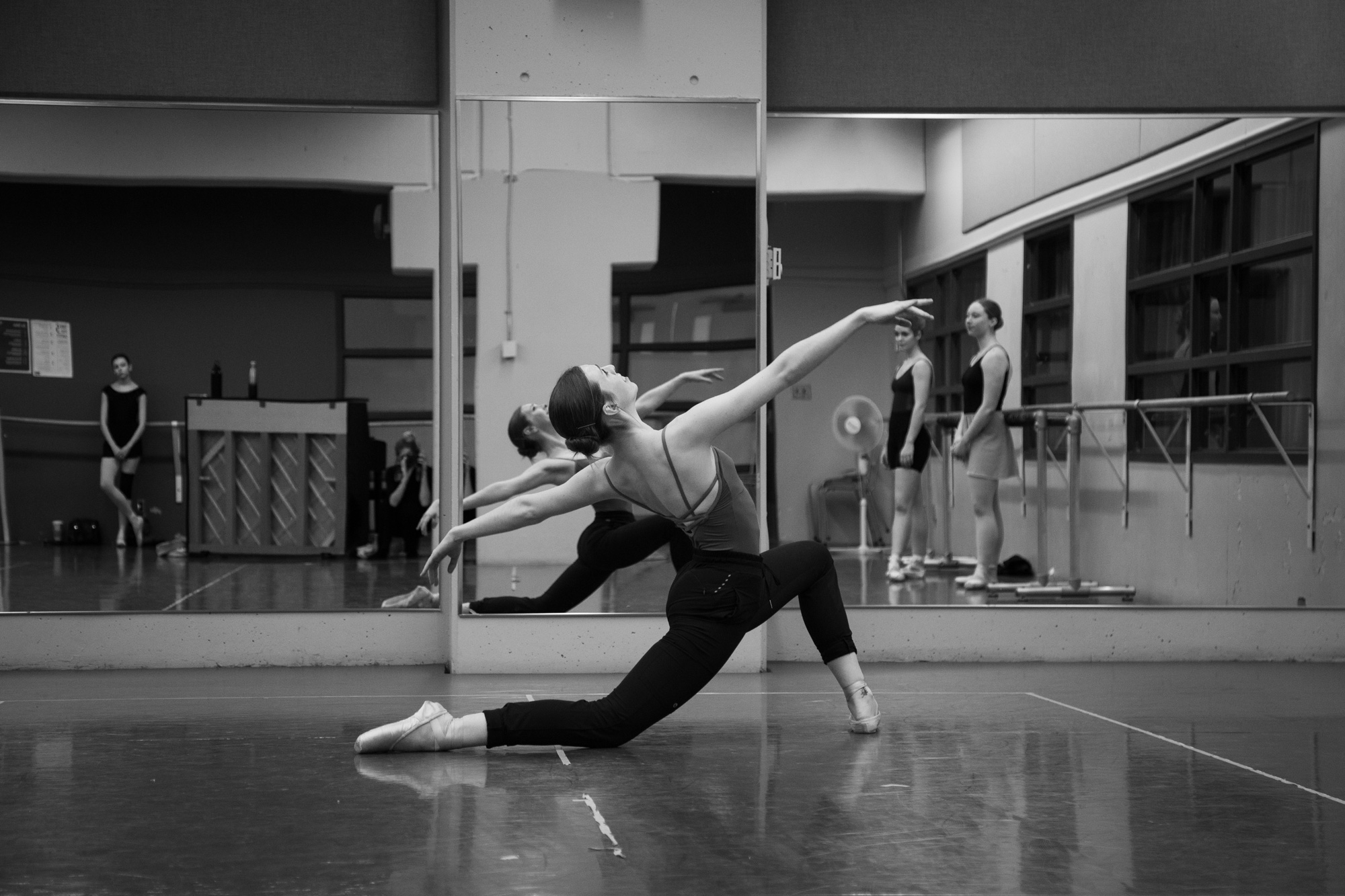 A dancer in a black leotard practices in the George Brown dance studios