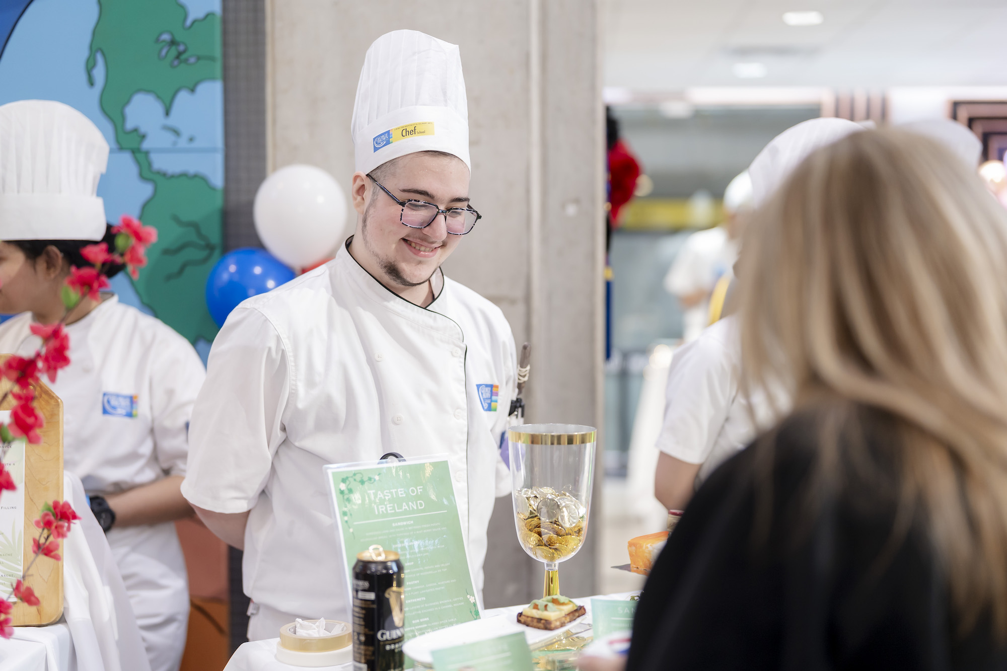 A chef student presents his baked items at the Room 4 Dessert event