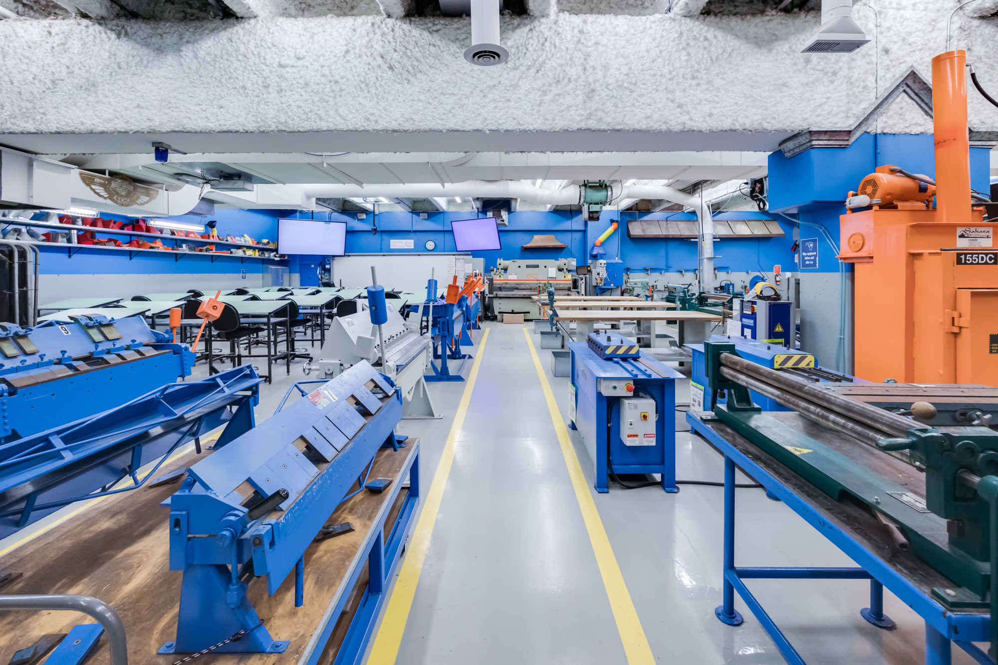 Sheet metal bending equipment in a bright classroom
