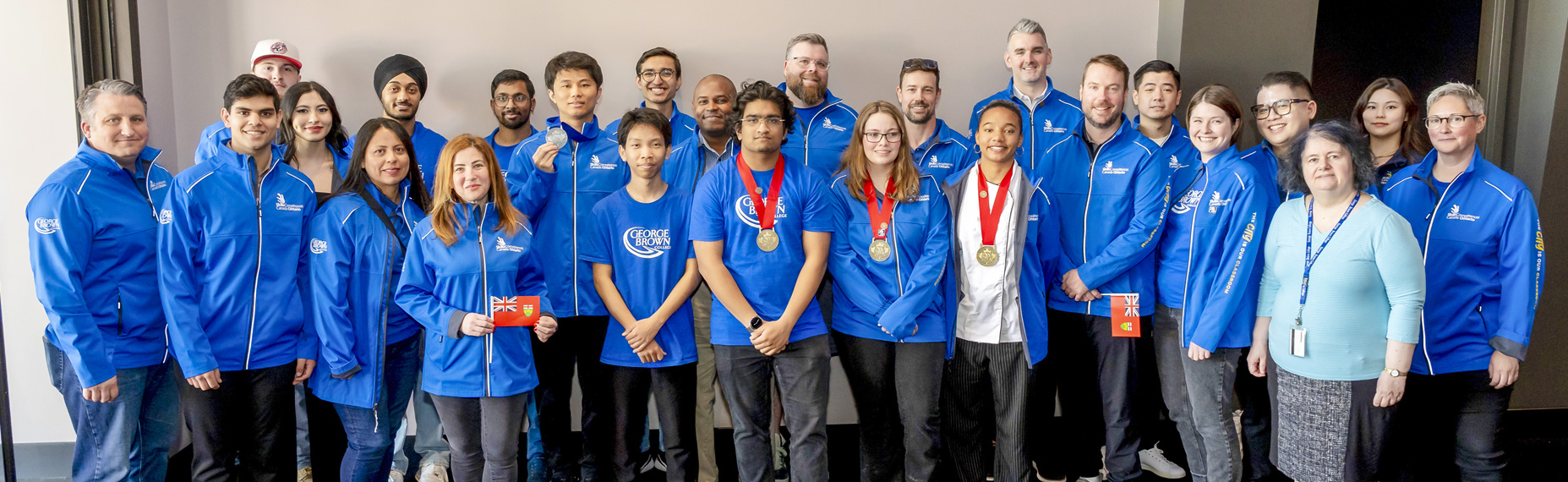A group photo of Team GBC at the Skills Ontario competition in blue shirts and jackets