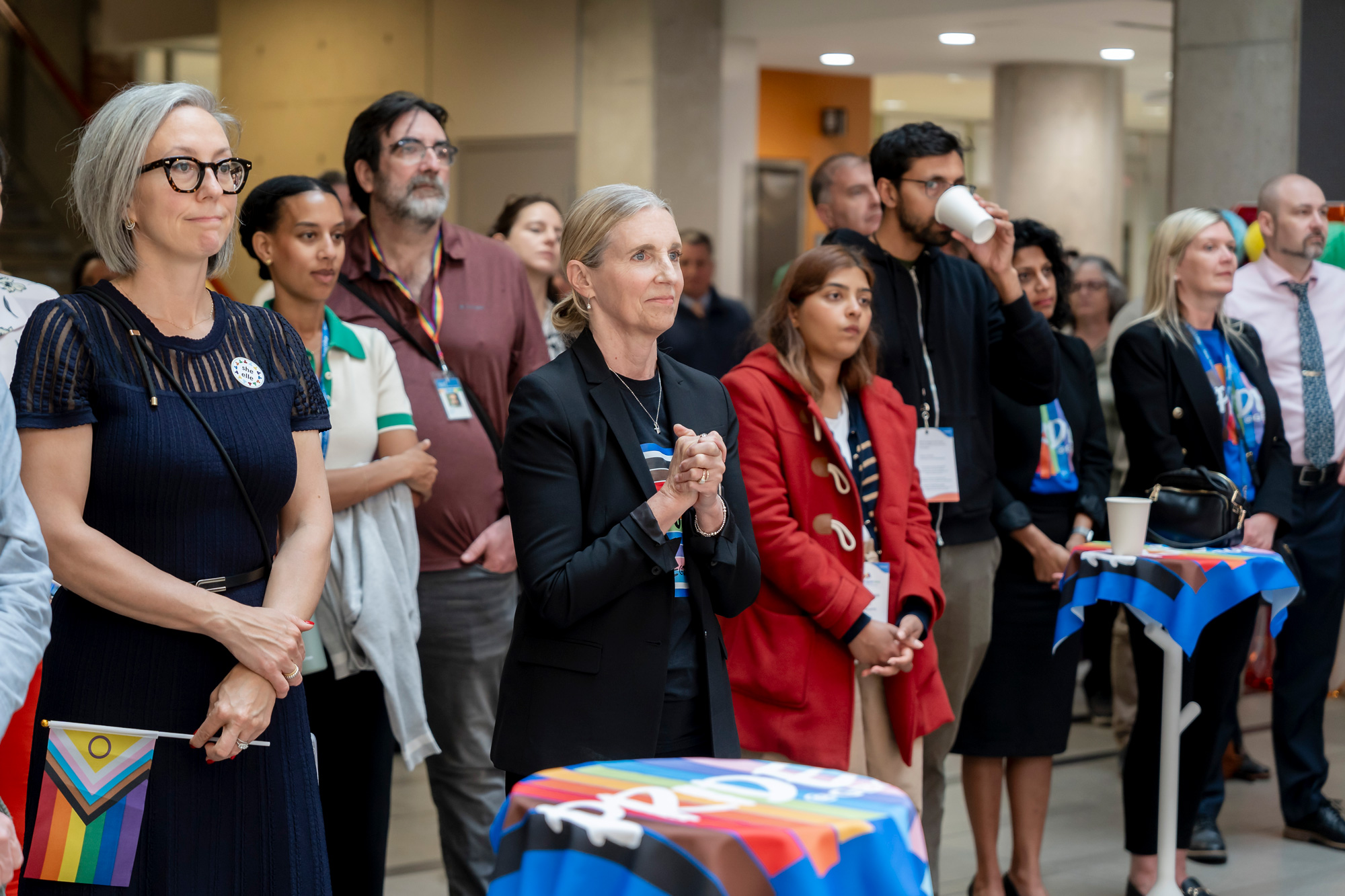 A group listens to the opening remarks at the Pride kick-off event