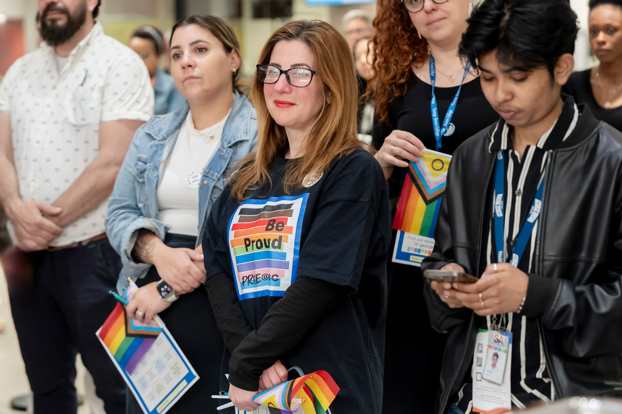 A group listens to Pride kick-off event the opening remarks