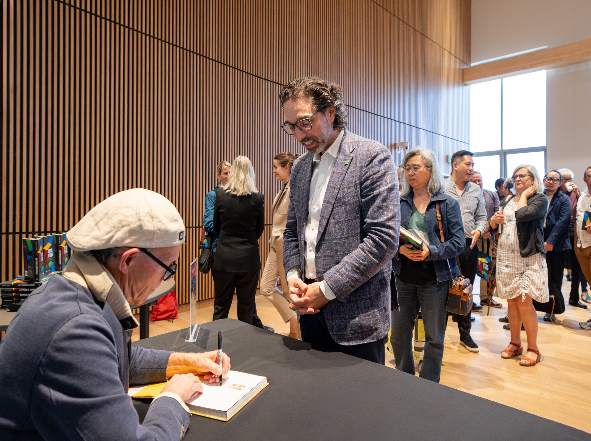 A guest has his copy of Rhytms of Change signed by the author, Mitchell Cohen