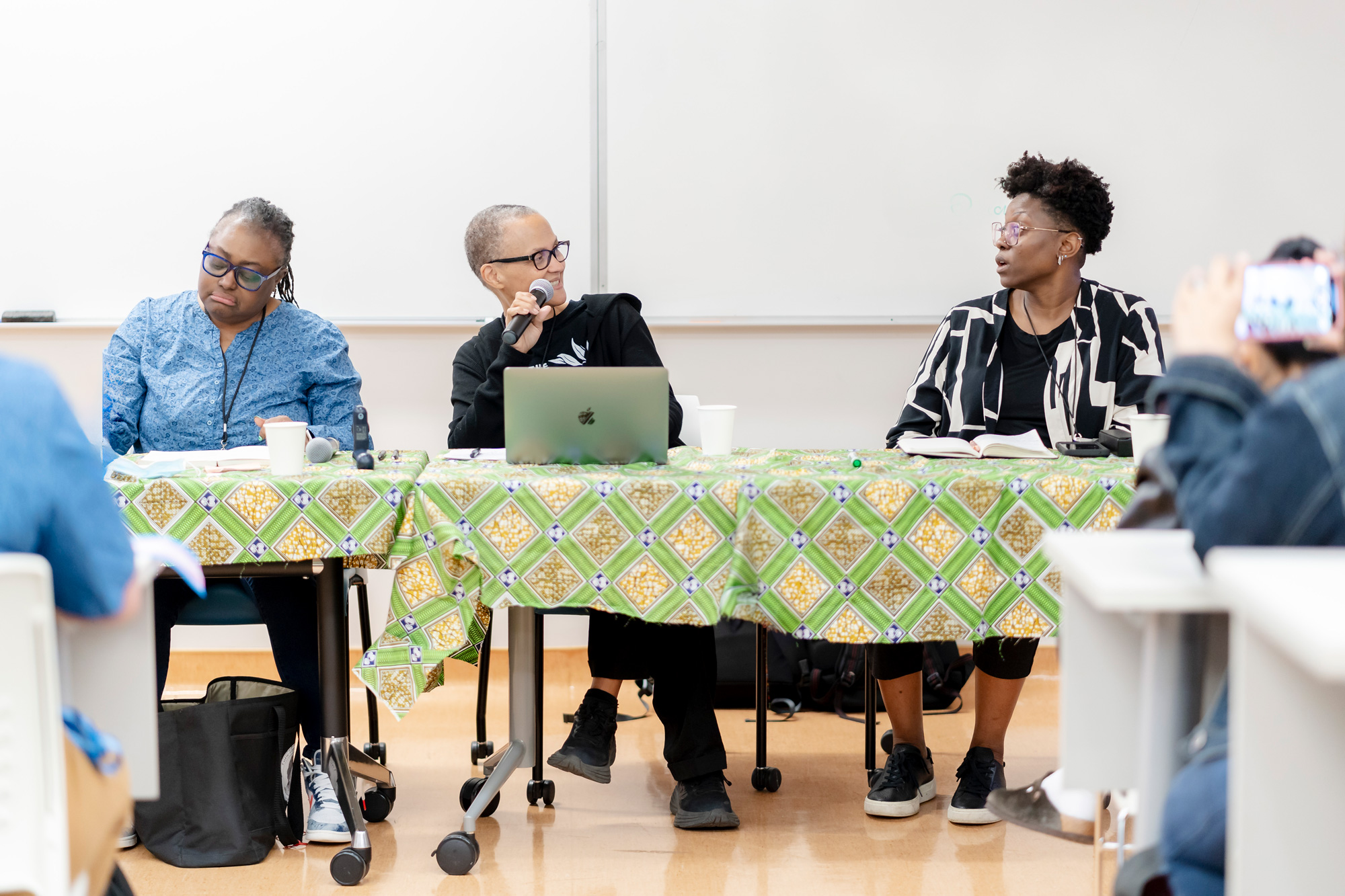Panelists at the Black Chat and Chill session are seated at the front of the room and speak to the audience