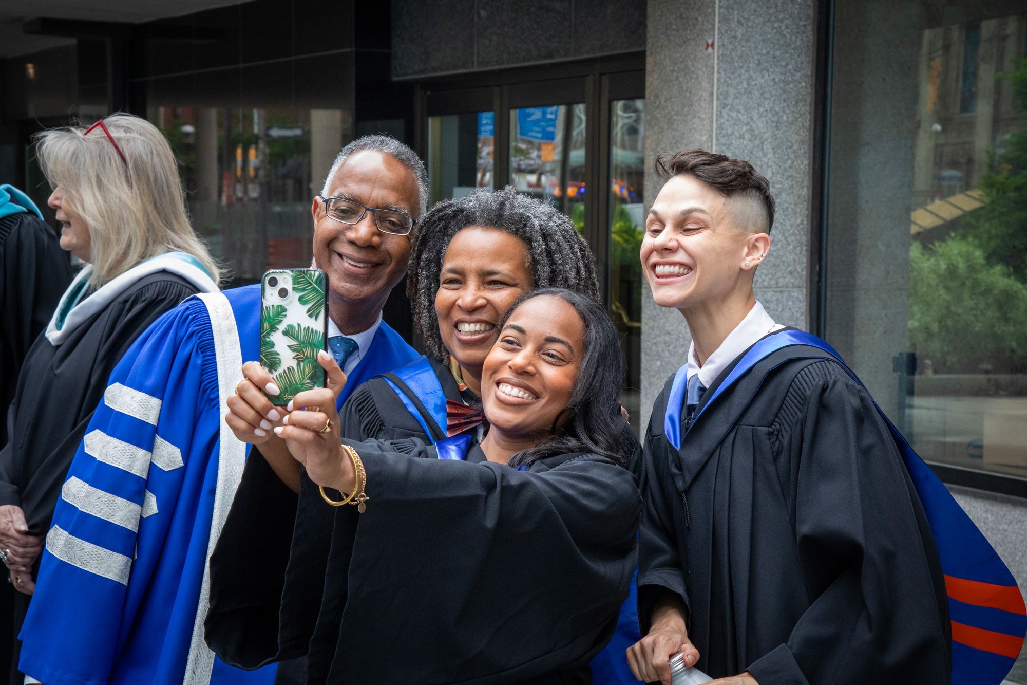Staff and students pose for a selfie with President Fearon at Convocation