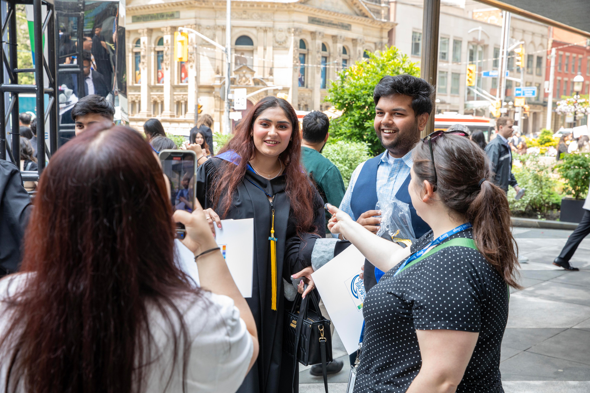 A graduating student engages with the social media team at convocation