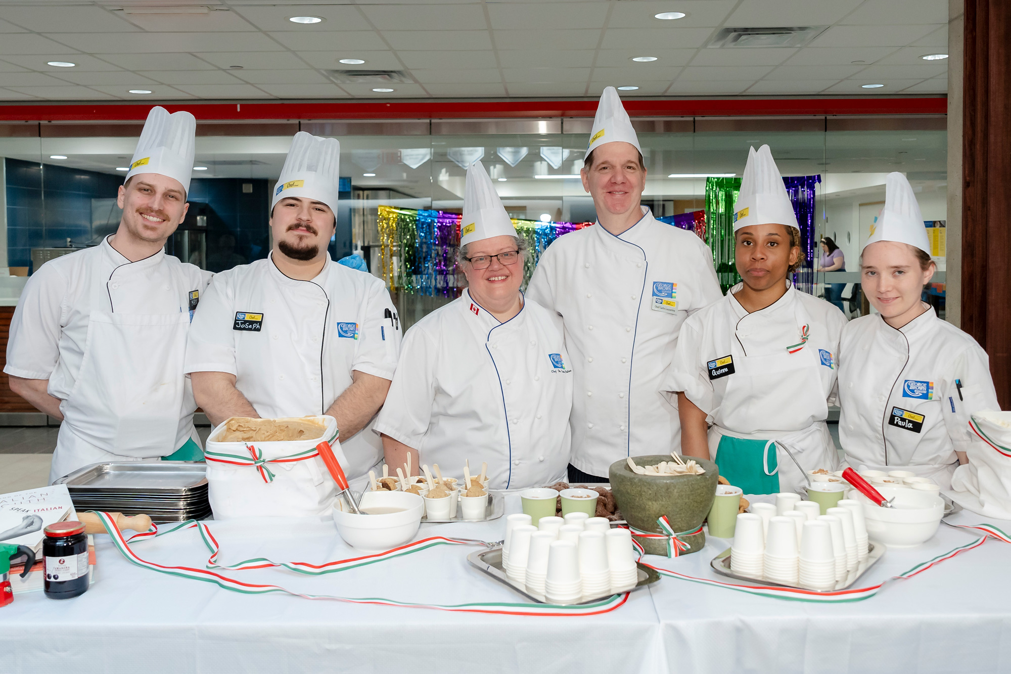 Chef students and faculty pose with italian sweets and gelato at the Pride kick-off event