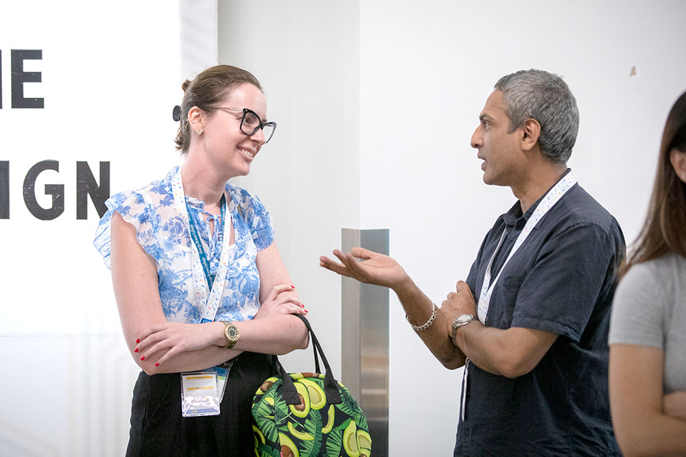 2 employees chatting at support staff day 2025