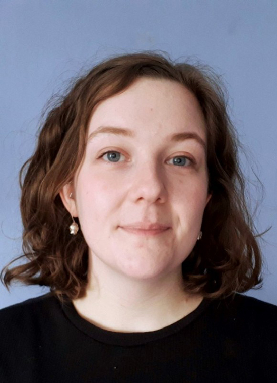A woman with brown hair and a black shirt