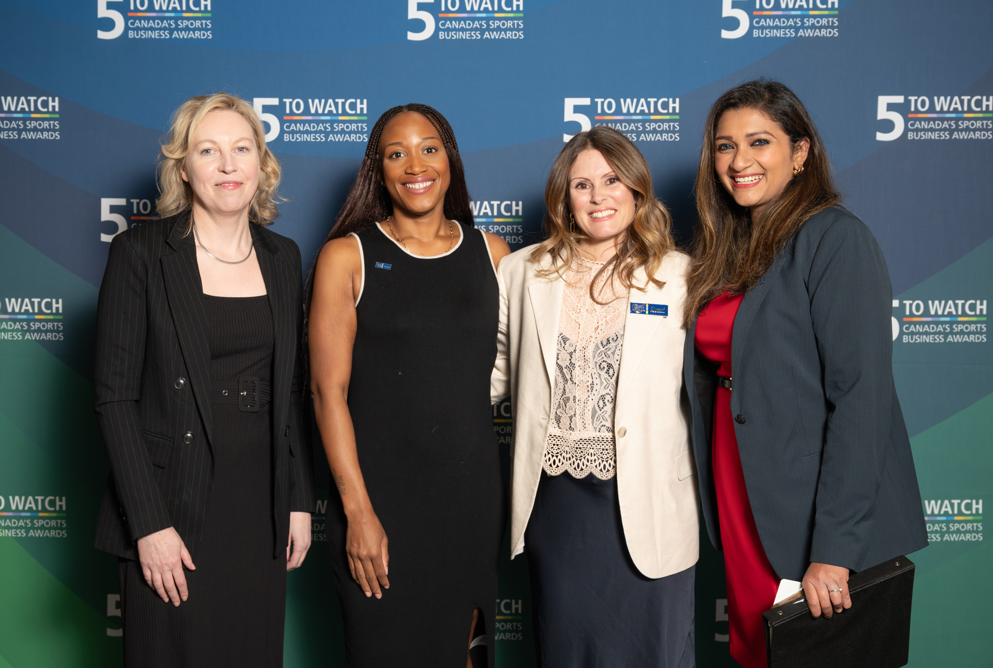 Alumni and staff pose together at the 2025 5 to Watch awards event