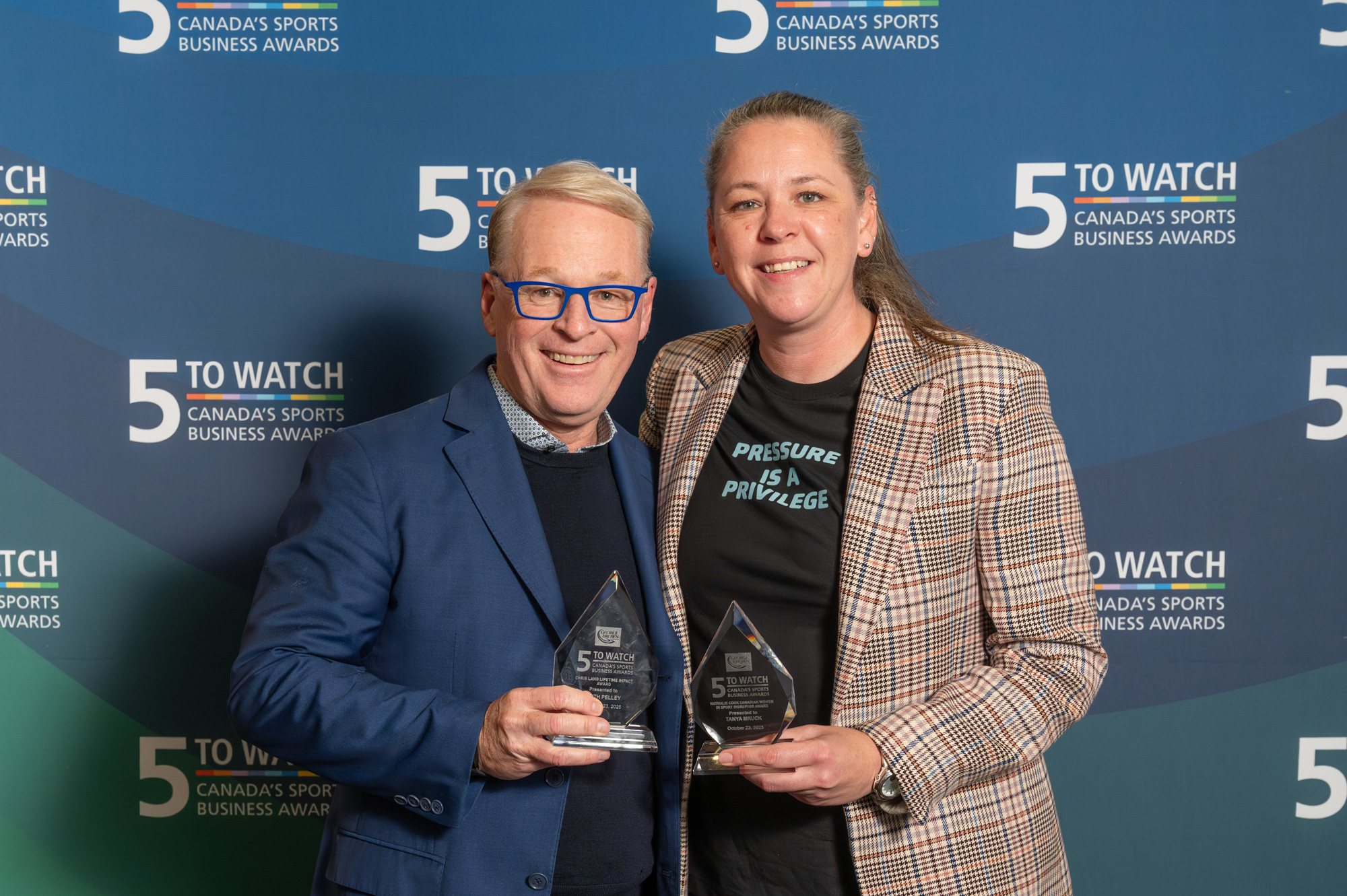 Award recipients hold of their awards at the 5 to Watch reception