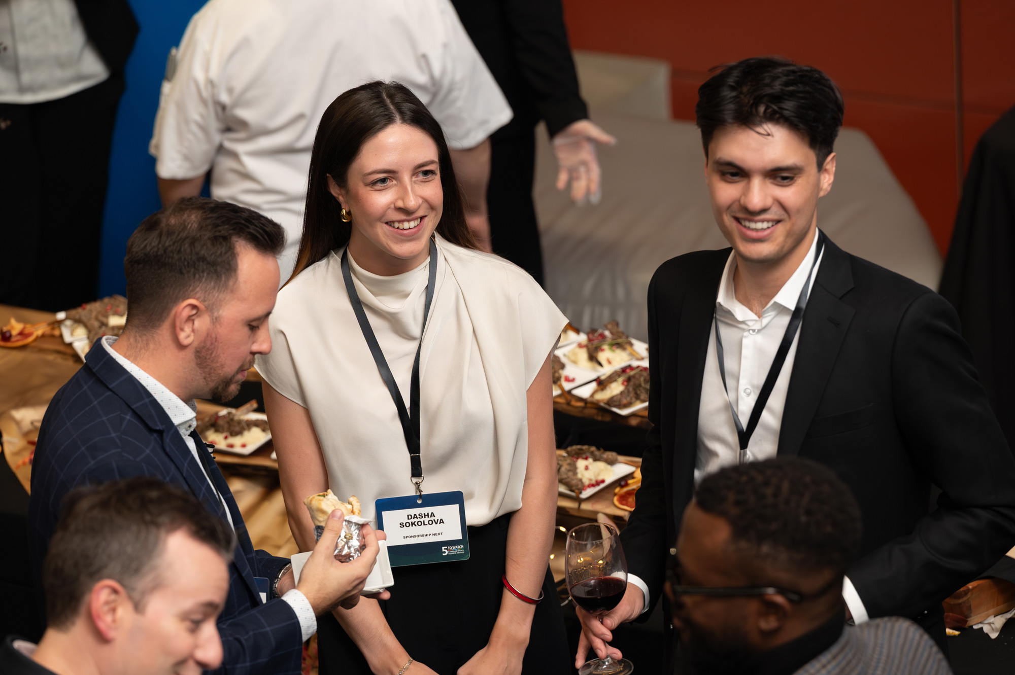 Guests at the 5 to Watch reception smile and chat