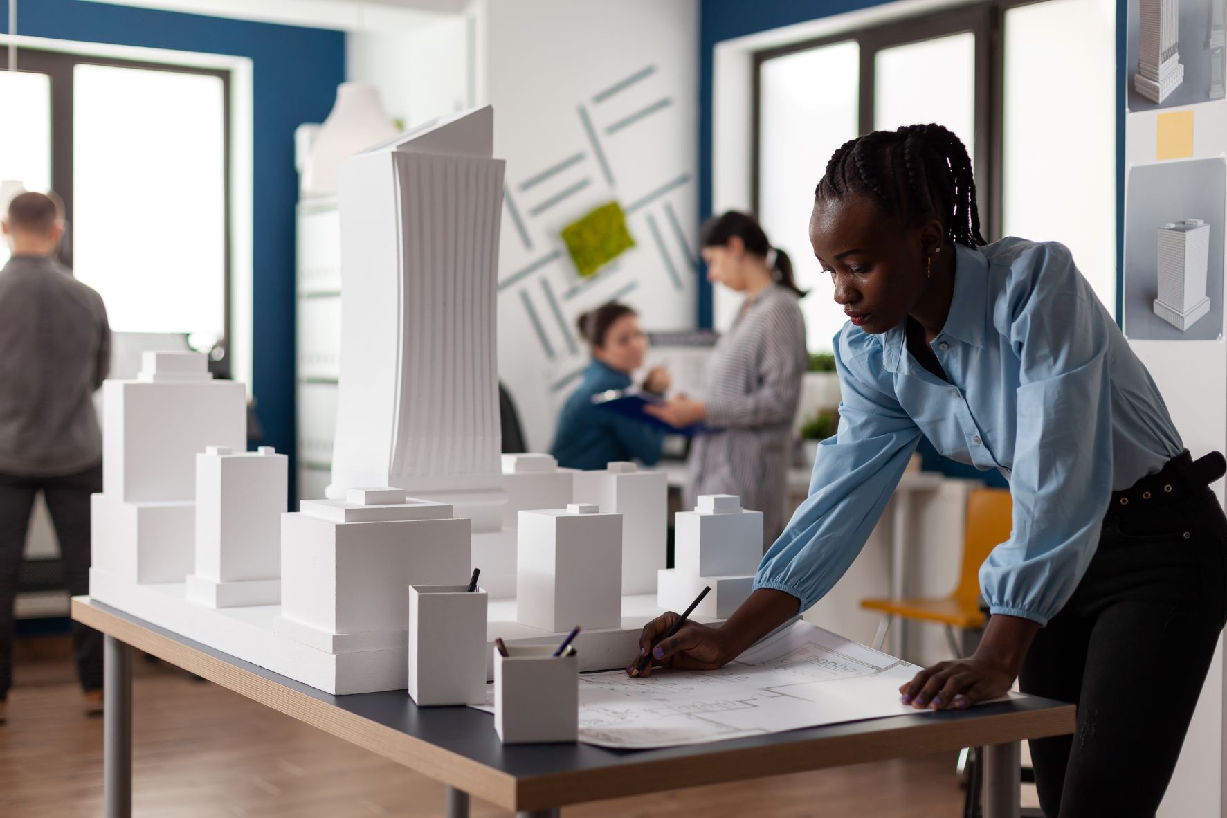 women studying a 3D model of a building site
