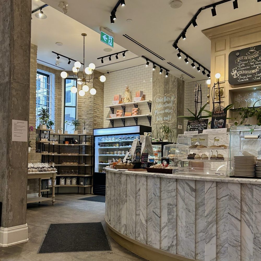 the inside of the pastry cafe shows displays of baked pastries