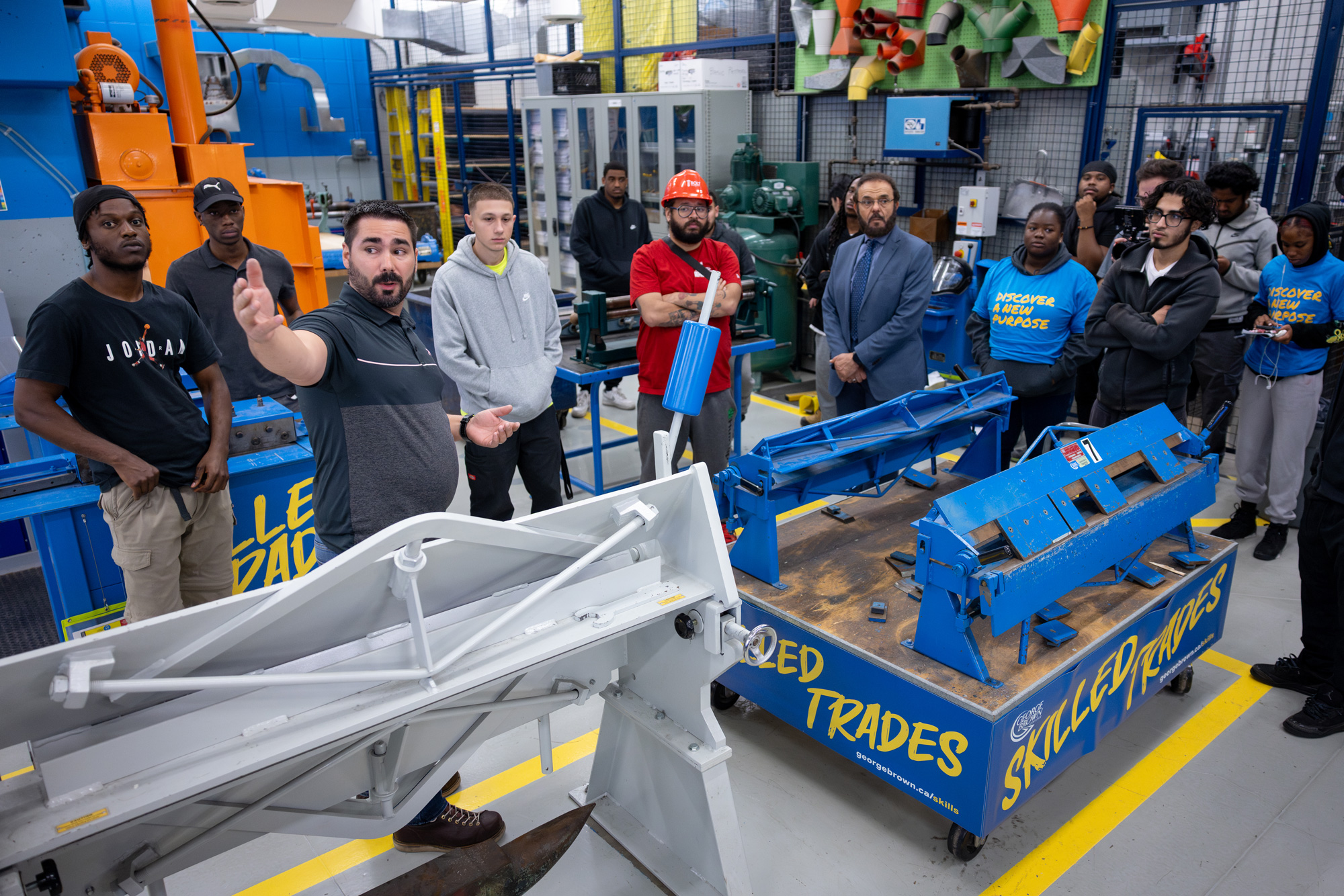 A group of students tour the sheet metal lab
