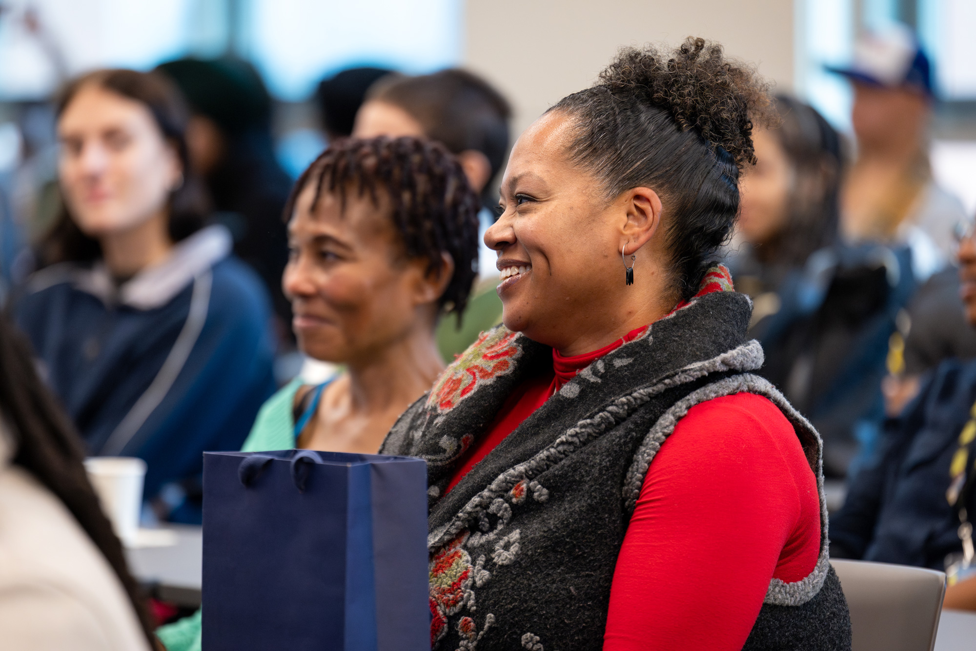 Audience members smile at the Dr. Mandela visit to George Brown