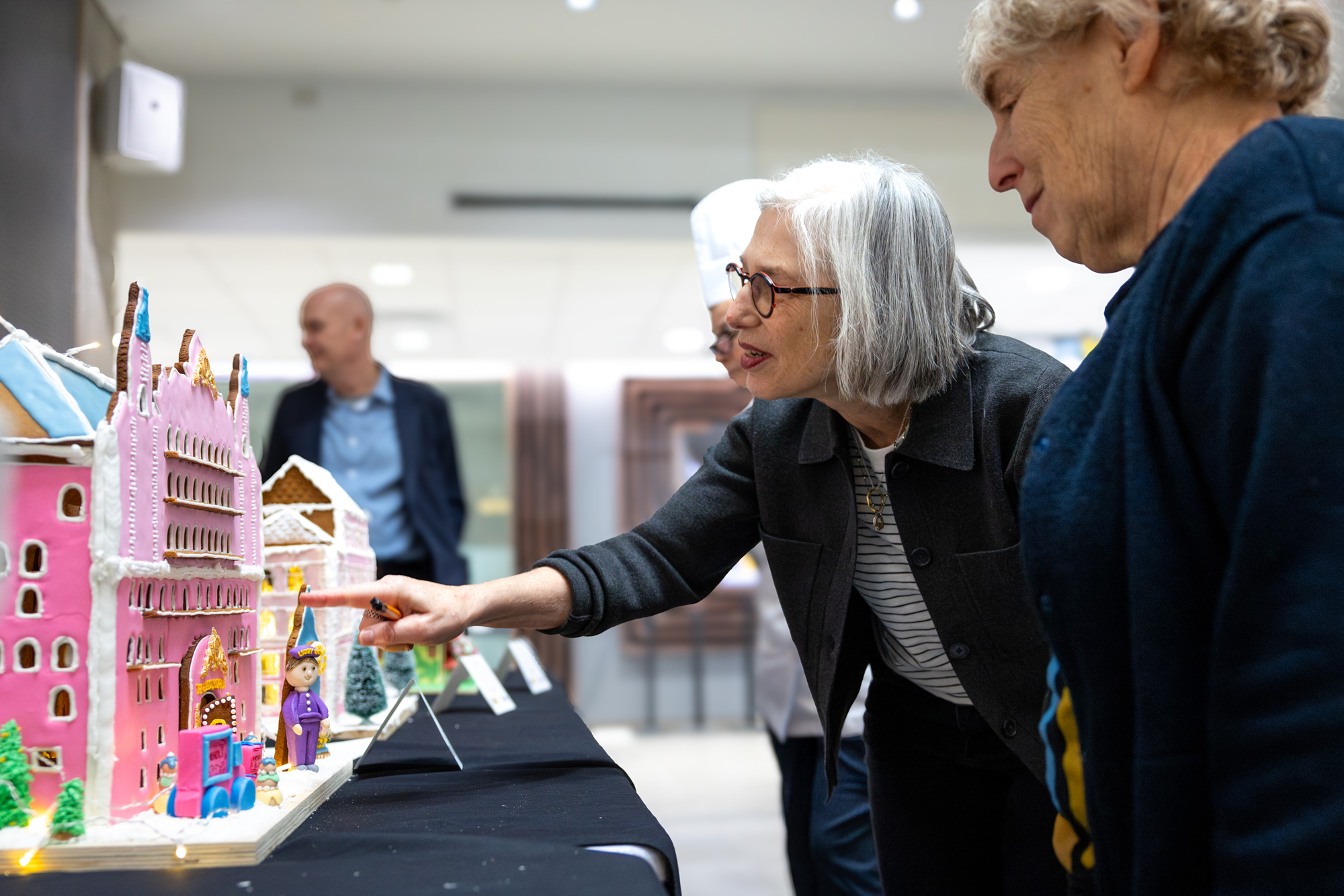 Judges at the gingerbread competition score the student entries