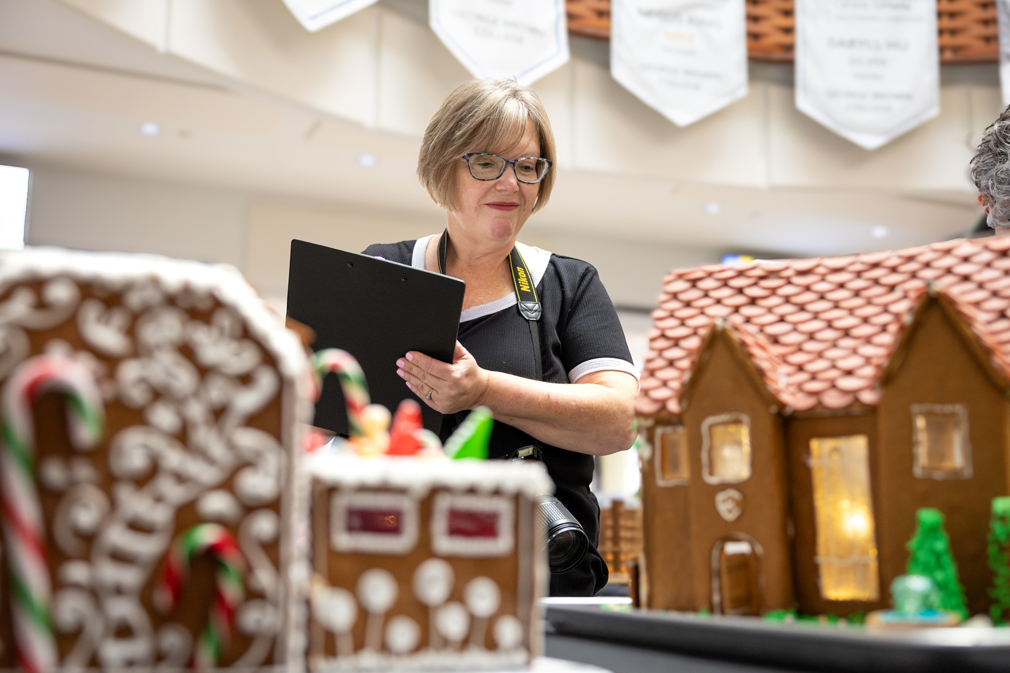 Judges at the gingerbread competition score the student entries