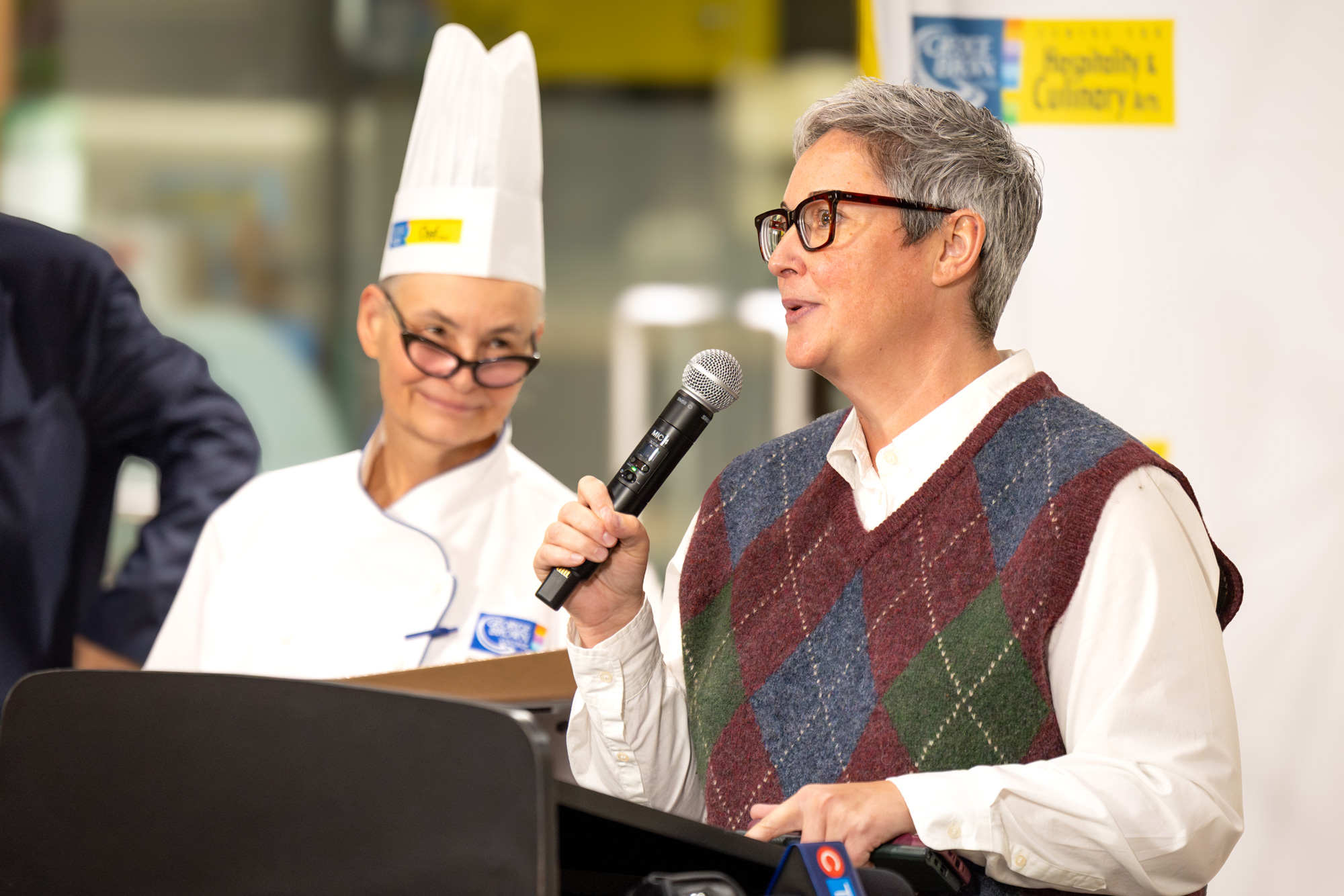 Tara Ferguson welcomes participants and guests at the 17th annual gingerbread competition 