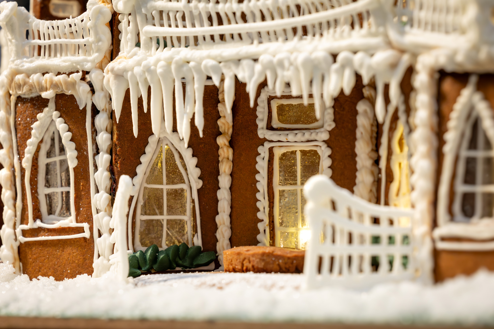Close up detail of the Christmas Carol gingerbread entry with arched windows and icing icicles