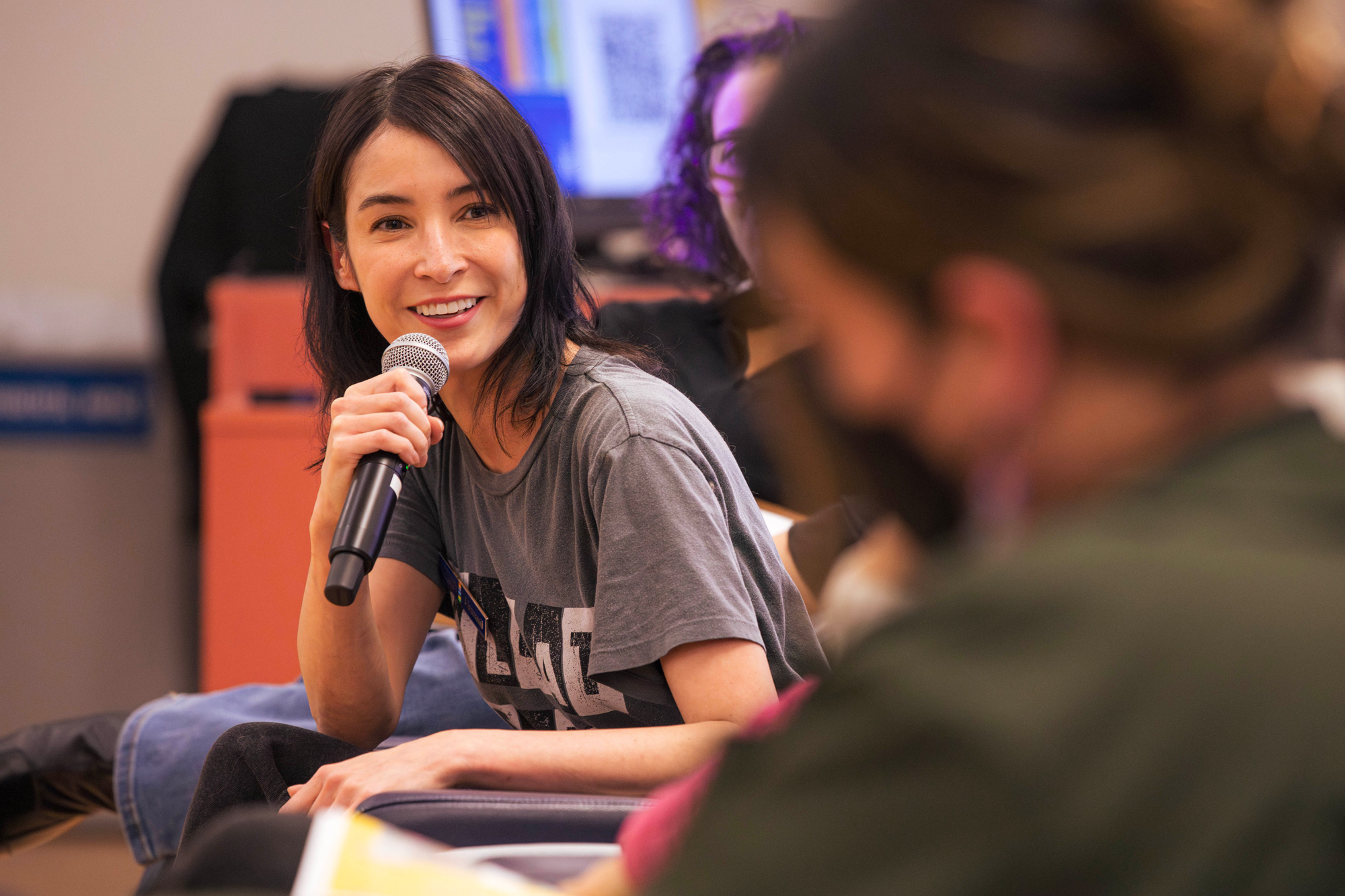 A panelist poses a question to another at the Human Rights Day event at George Brown Polytechnic