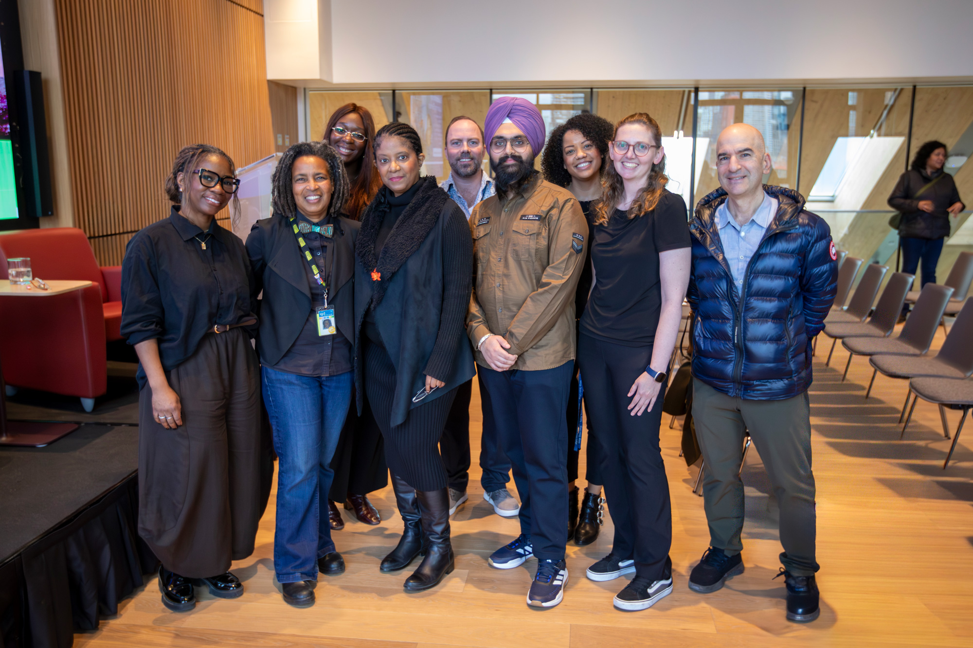 College staff pose with Dr. Ingrid Waldon at a screening and fireside chat on her book and film, There's Something in the Water