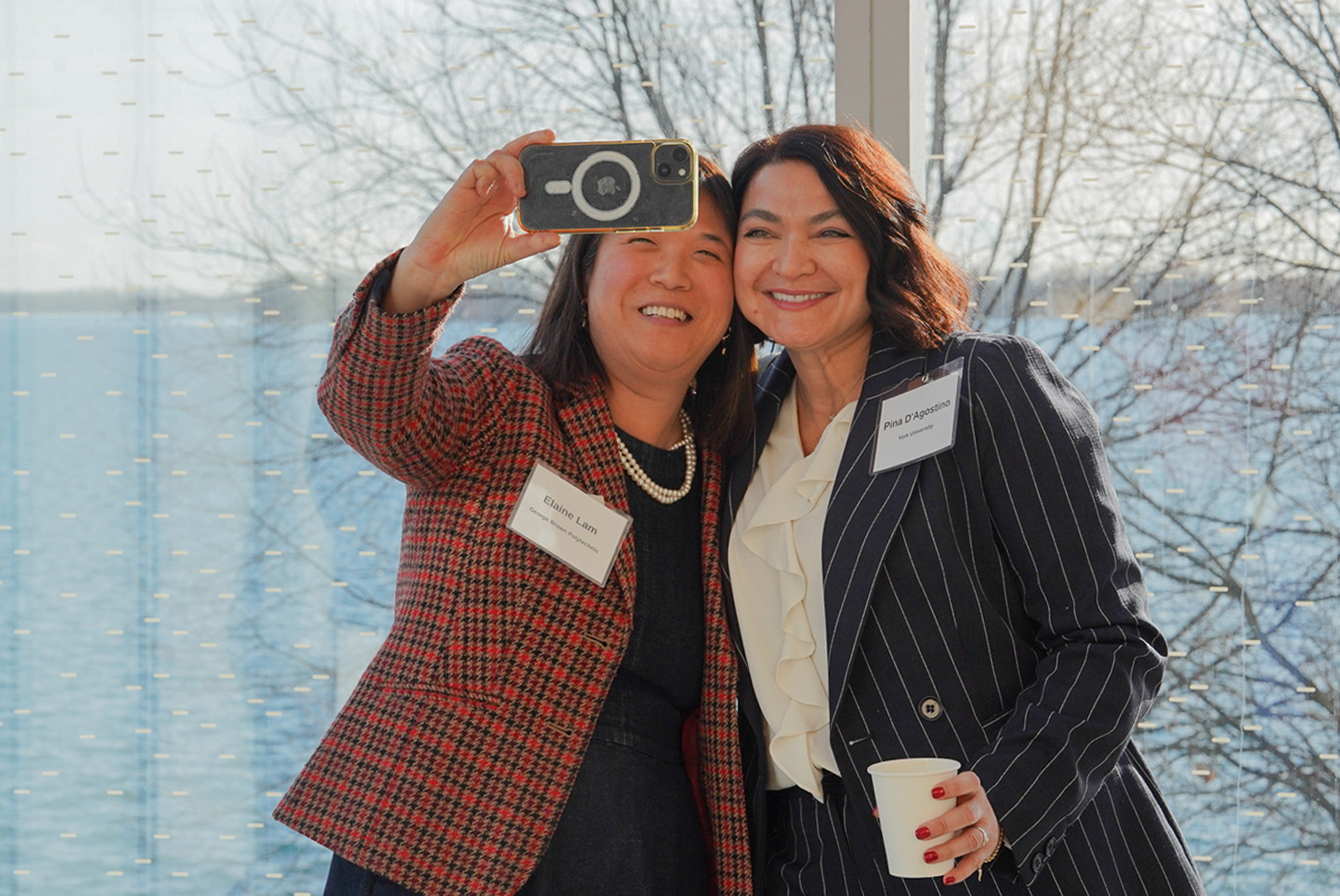 Two attendees at the OBAC event pose for a selfie