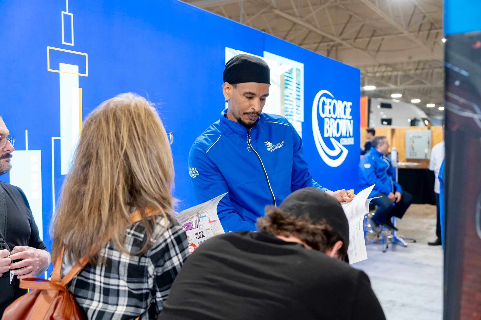 Benjamin Abebe at Skills Ontario chatting with prospective students