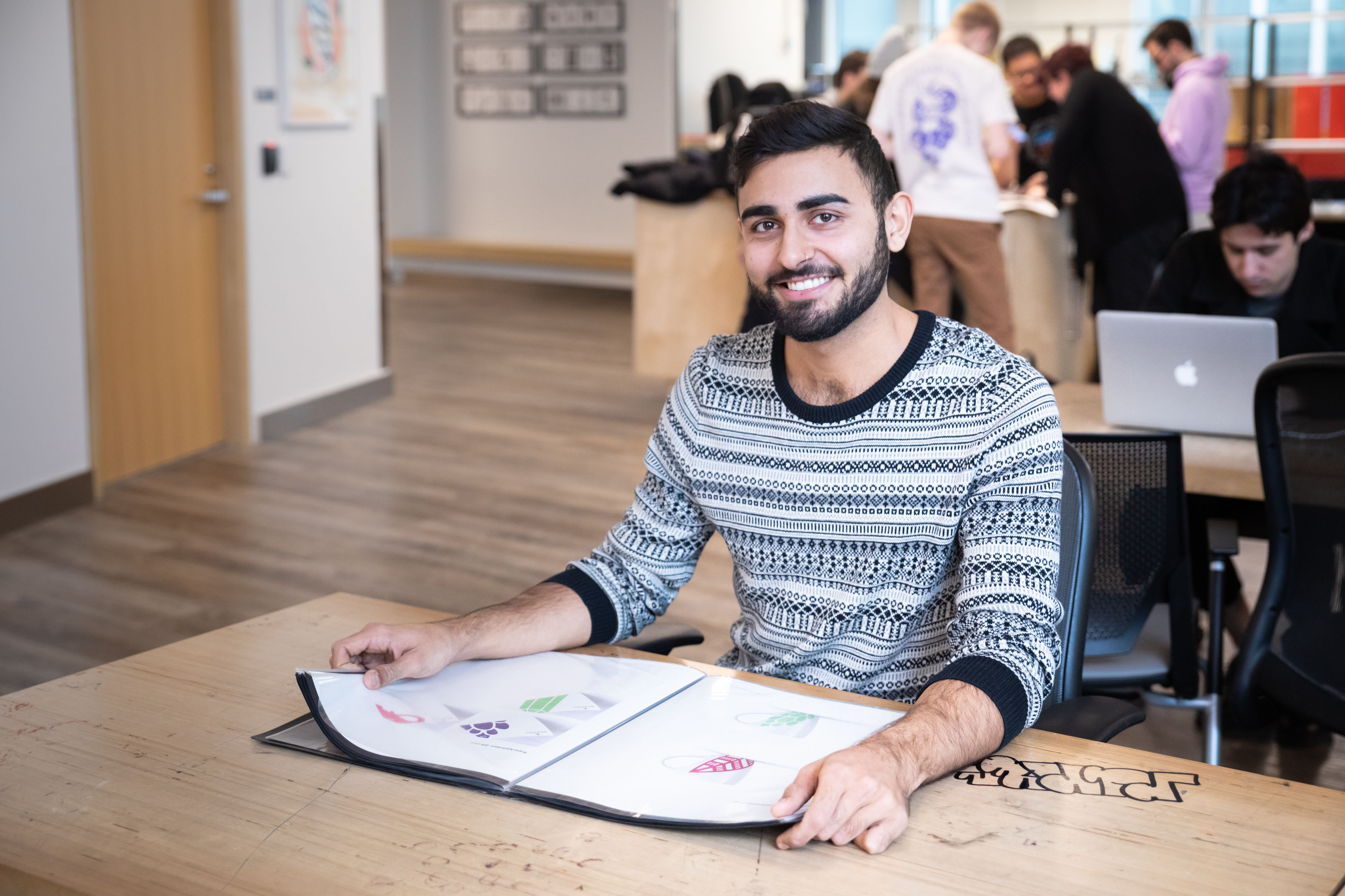 Design Student looking at a portfolio