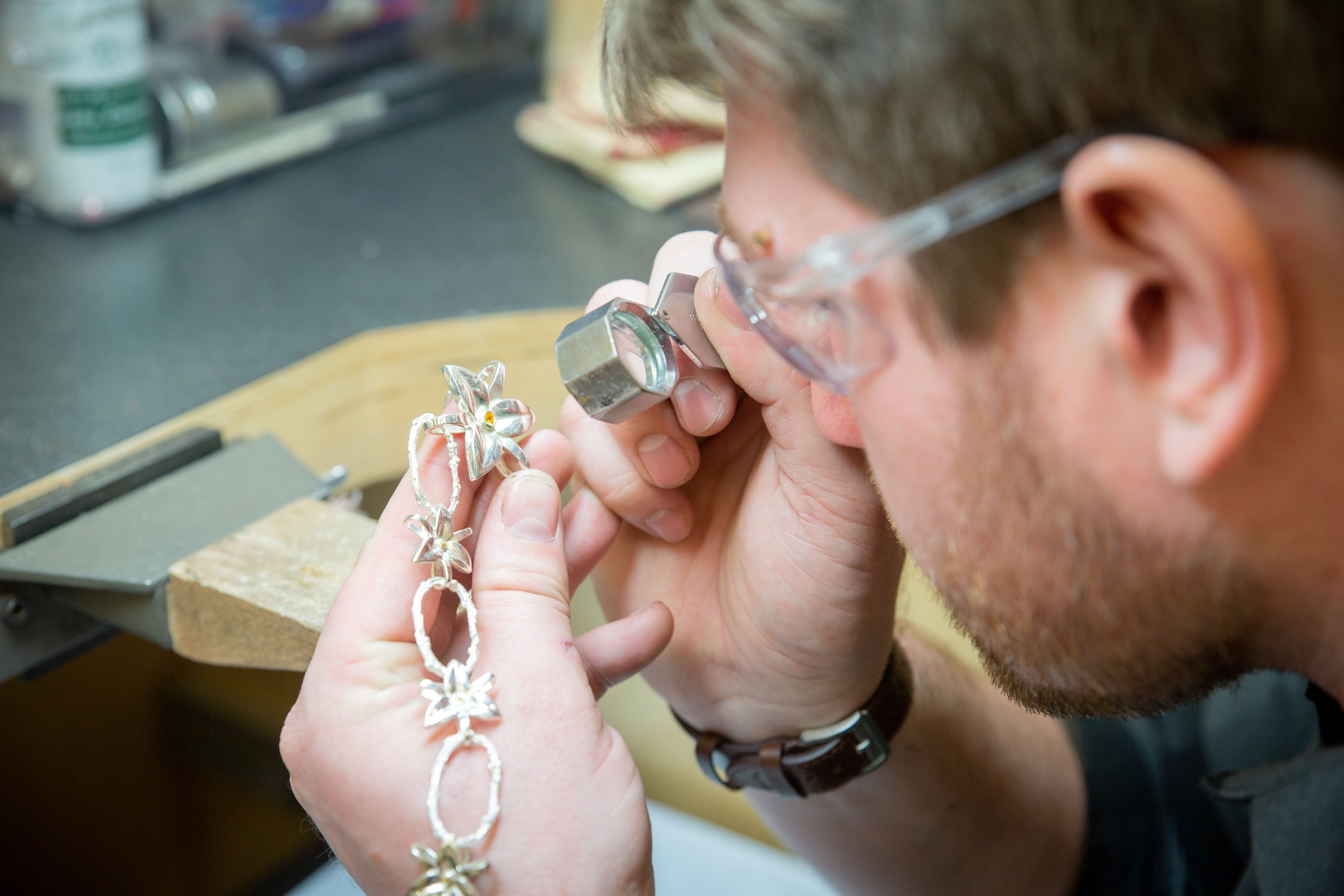 jeweler checking a necklace
