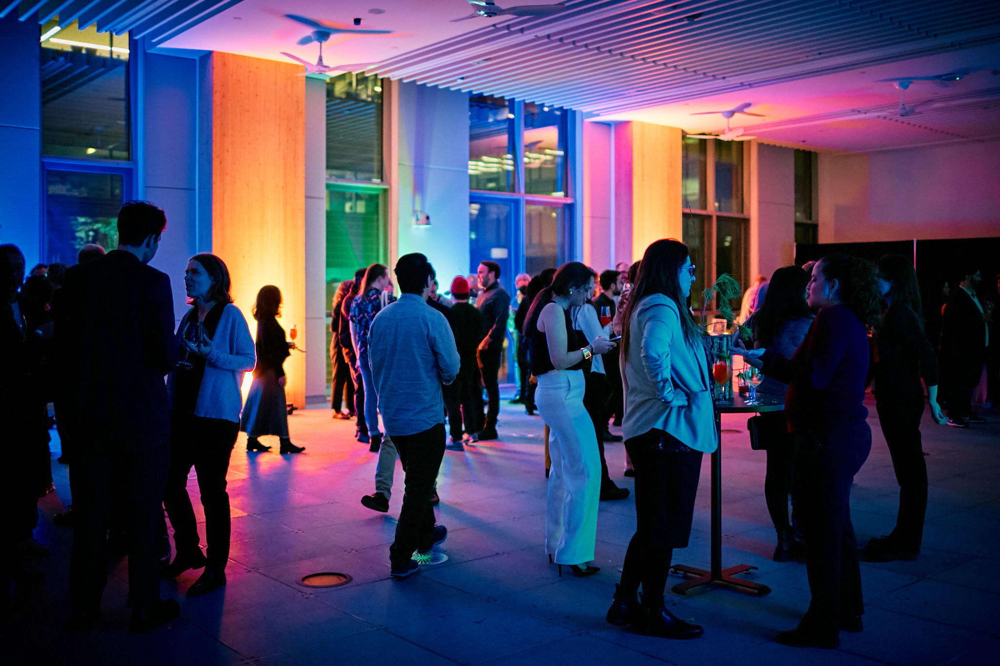 People standing and talking around high tables