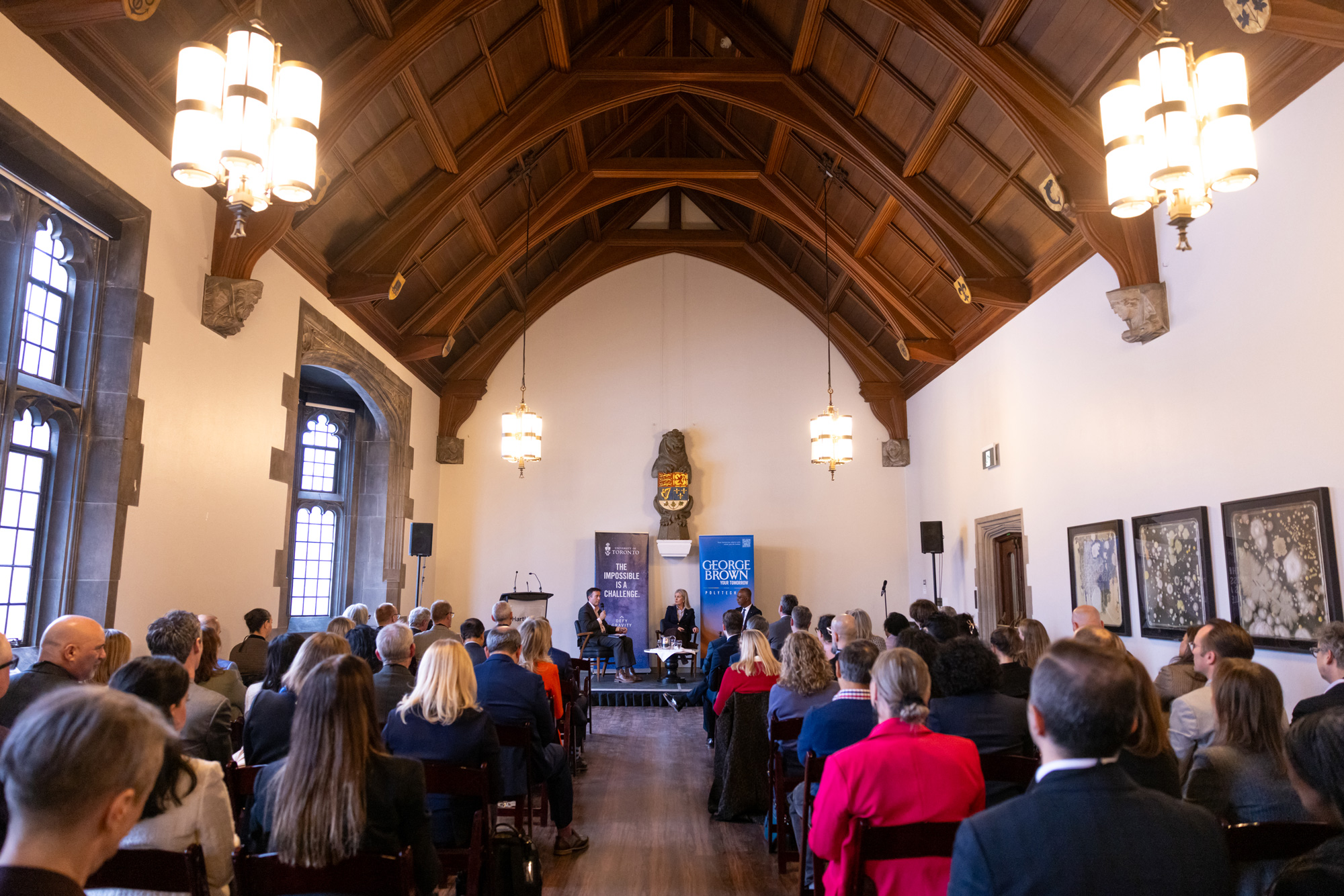 Education and industry leaders listen to panelists speak in Hart House