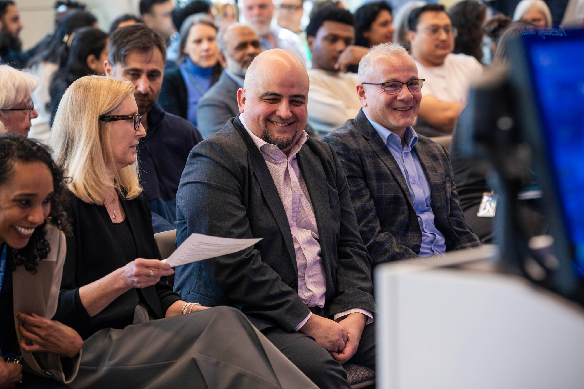 AI Innovation Showcase guests network with other staff