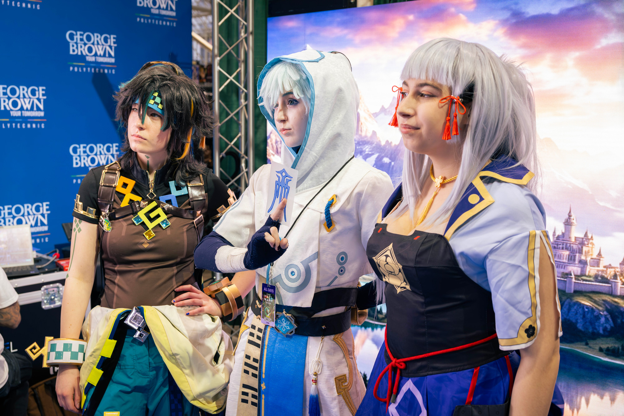 A group in cosplay pose in front of the LED wall at Comicon