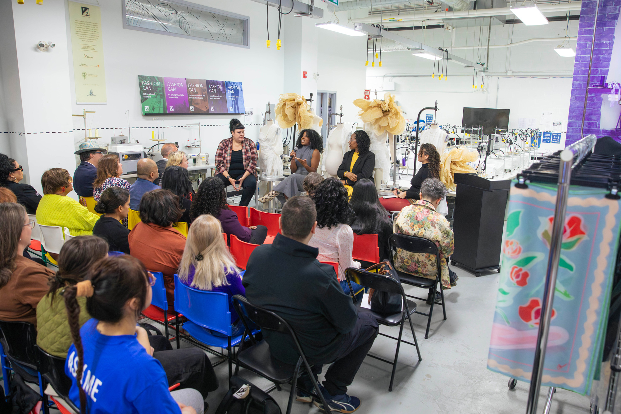 Alumni panelists speak at the International Women's Day event at the Fashion Exchange