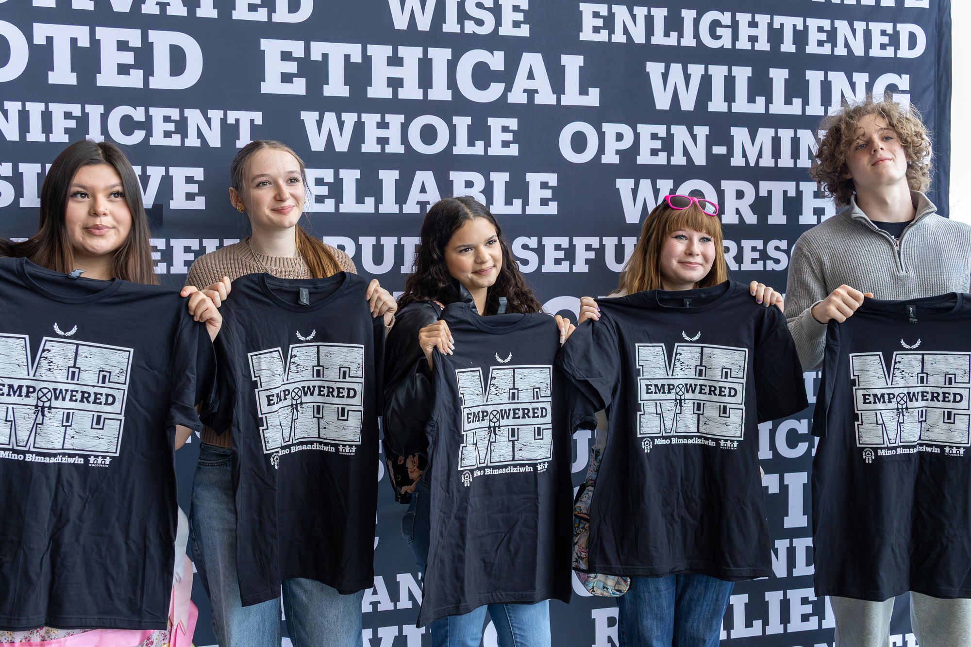 Participants at the Youth Empowerment Conference pose with t-shirts
