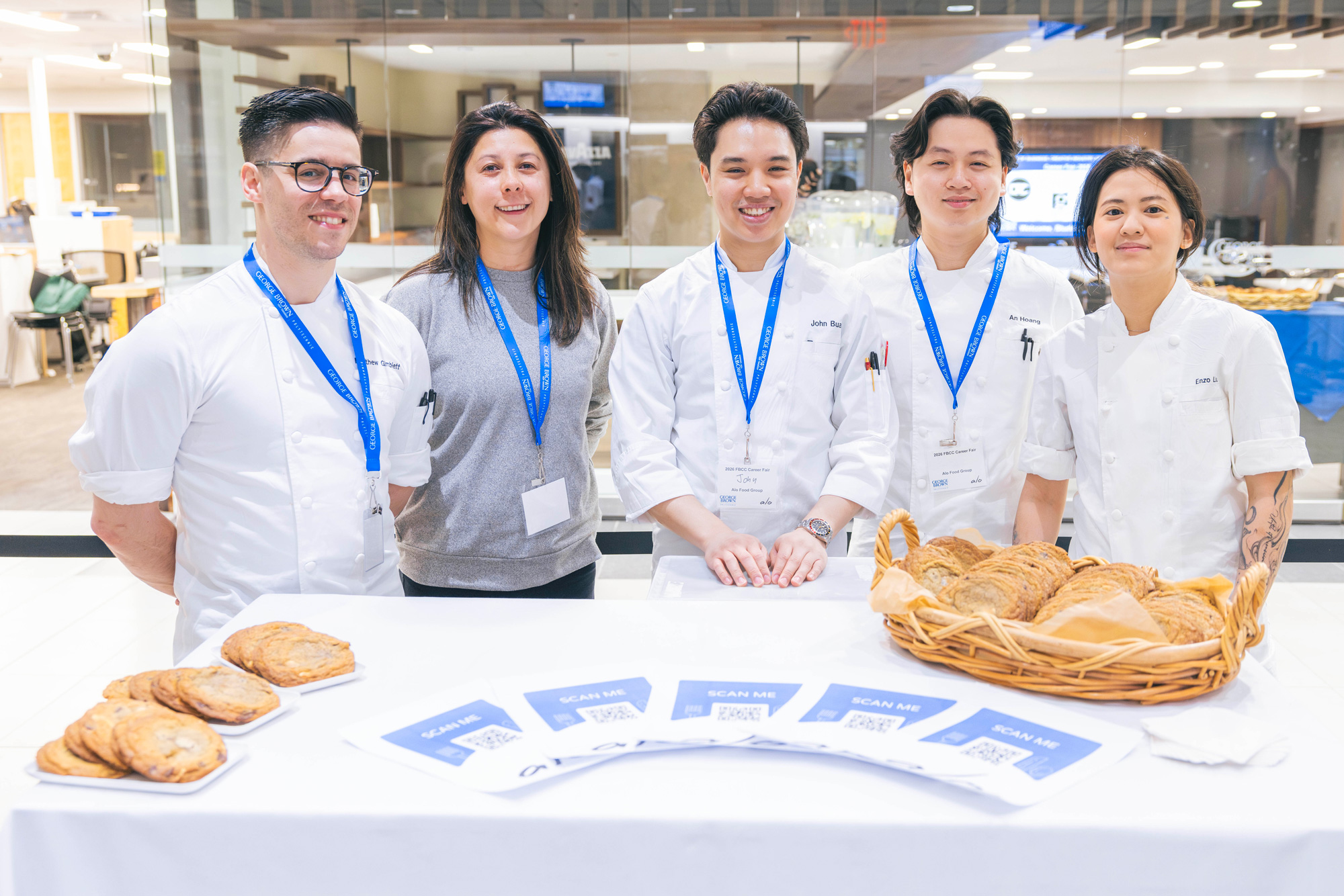 Hospitality employers pose together behind their booth