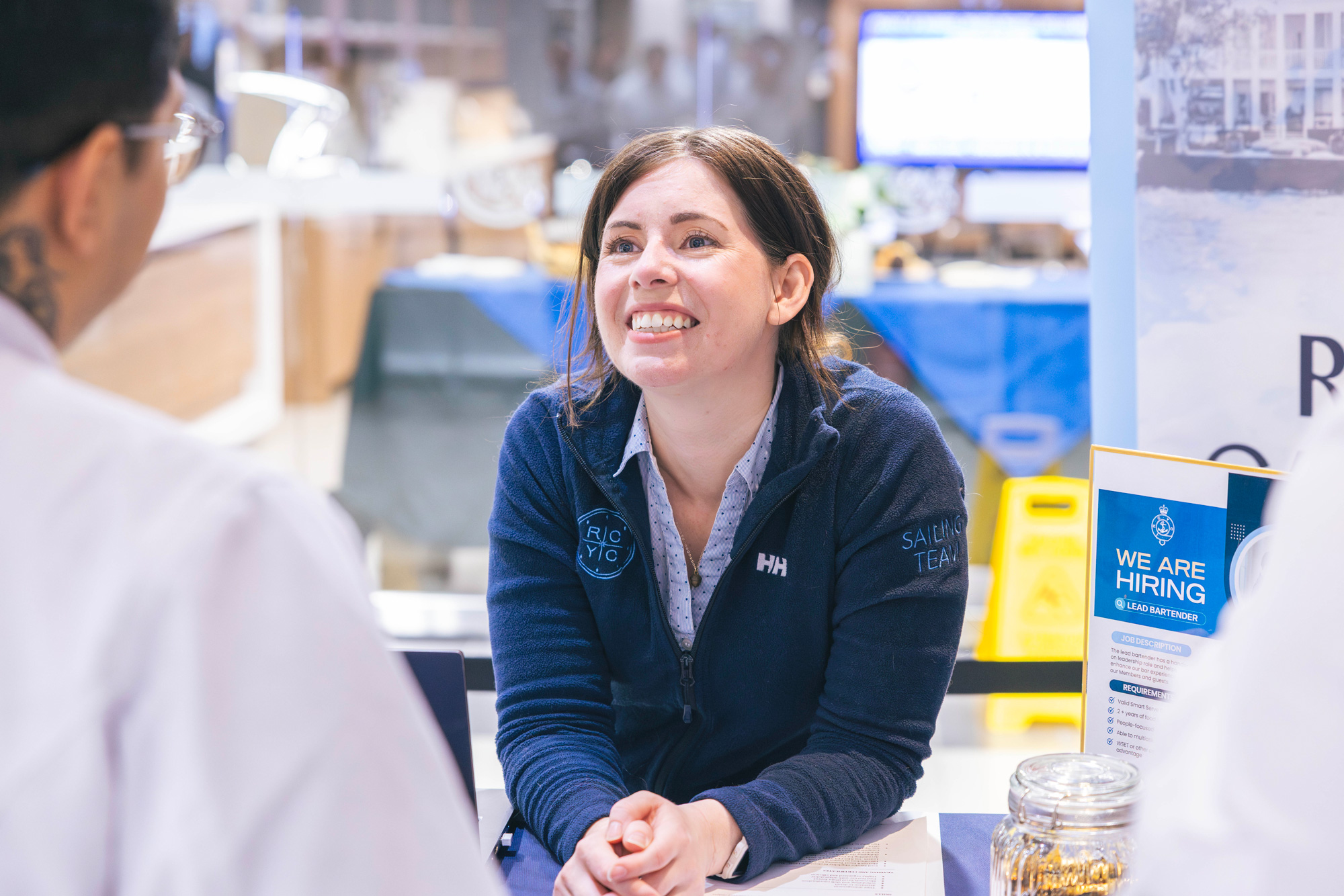 Employers at the career fairs chat with students at their booths