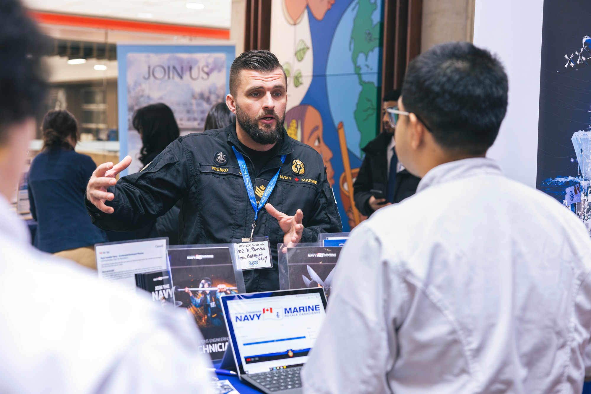 Students chat with Royal Navy representatives at the career fair