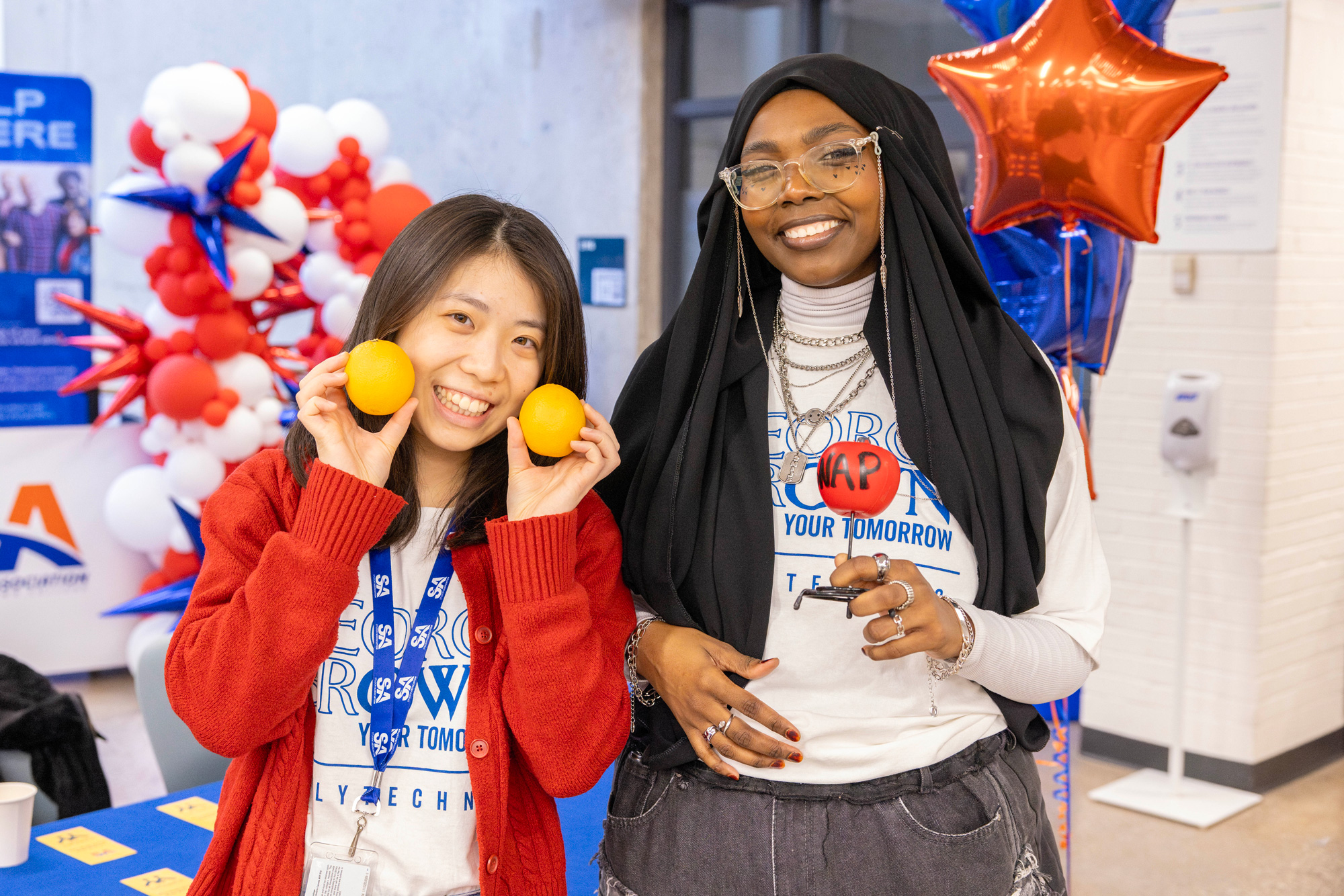Two students support the SNAP table at the spring open house