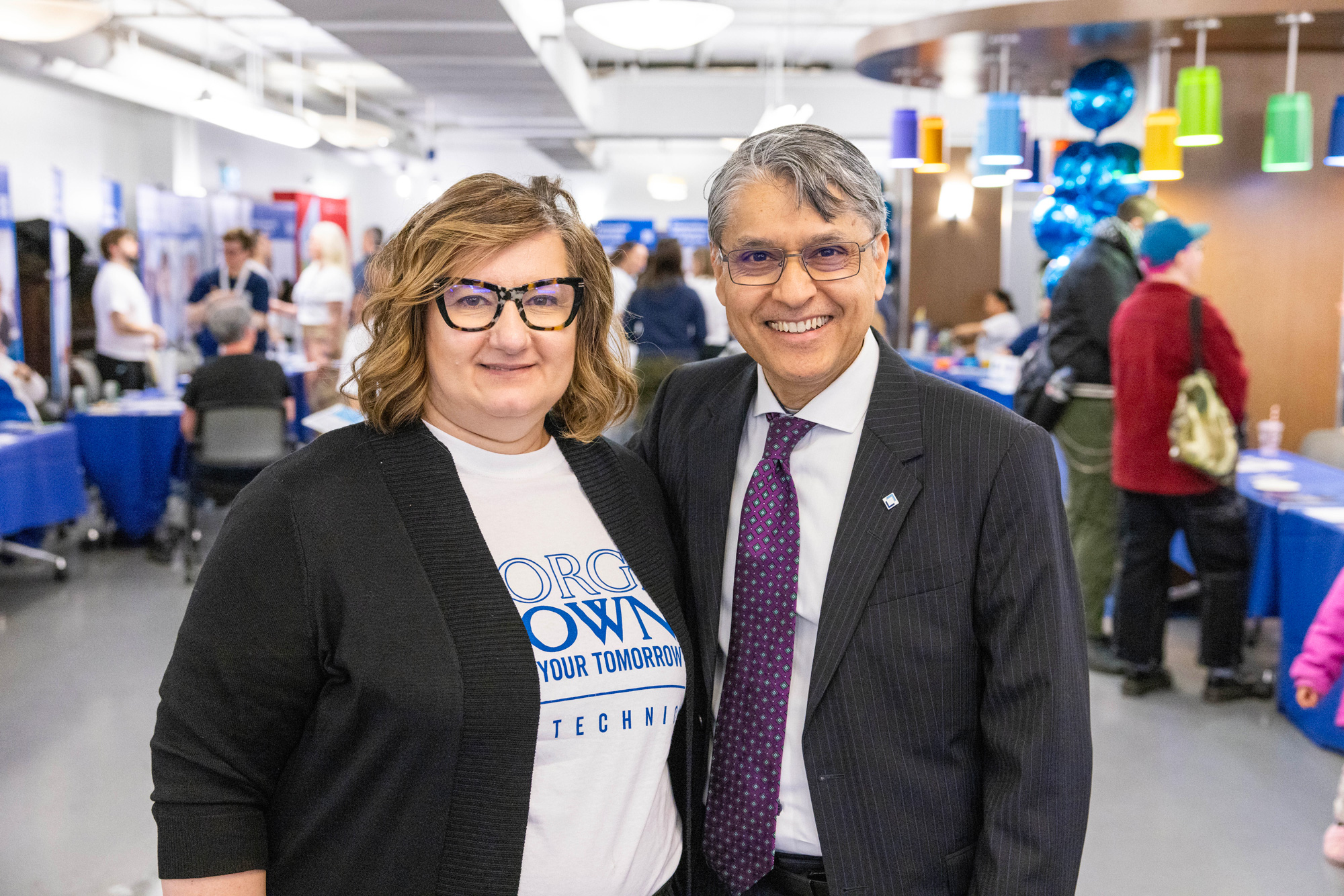 Provost and VP Academic Dr. Hassun Malik poses with staff at the spring open house