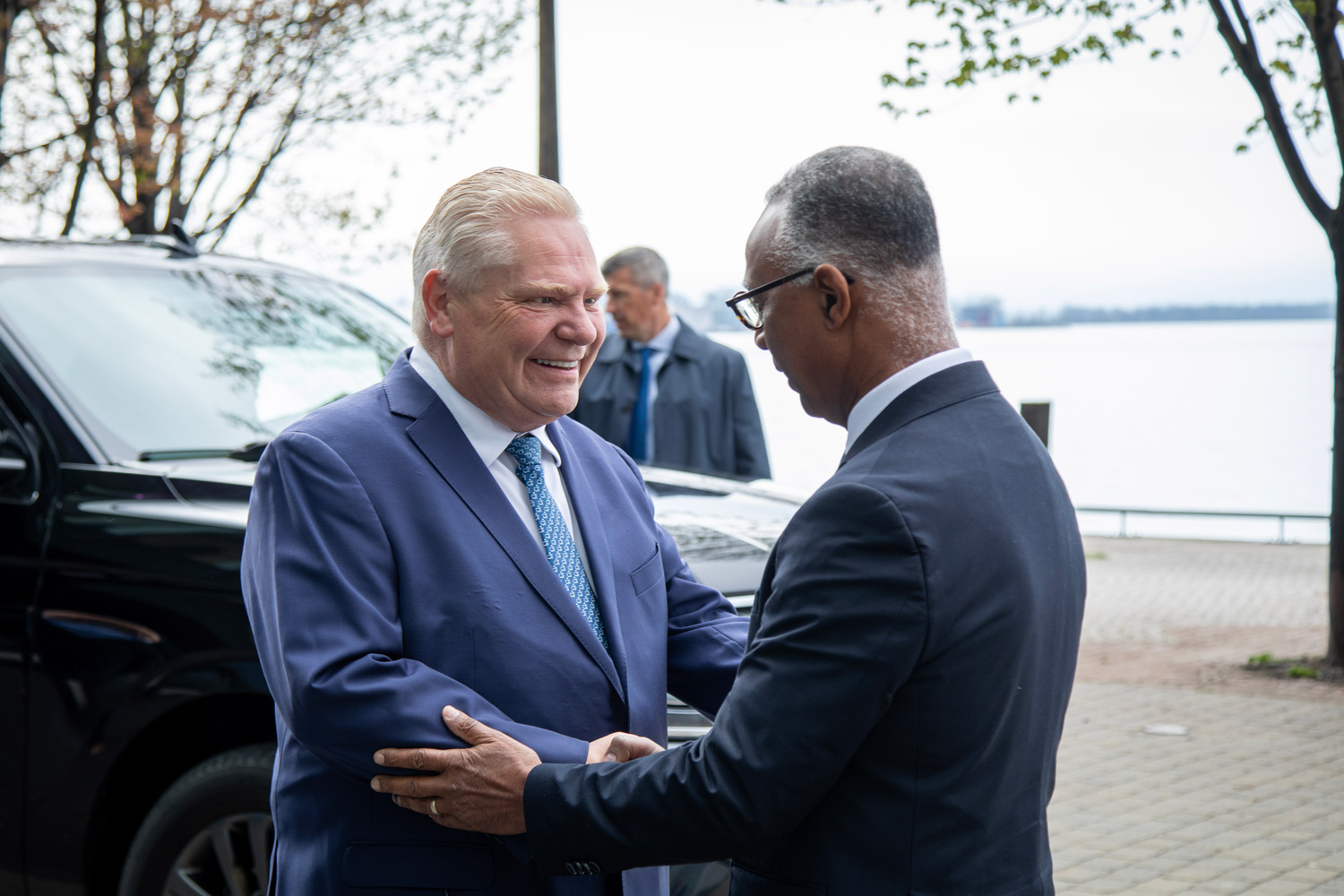 Dr. Fearon greets Premier Ford outside of the Waterfront Campus