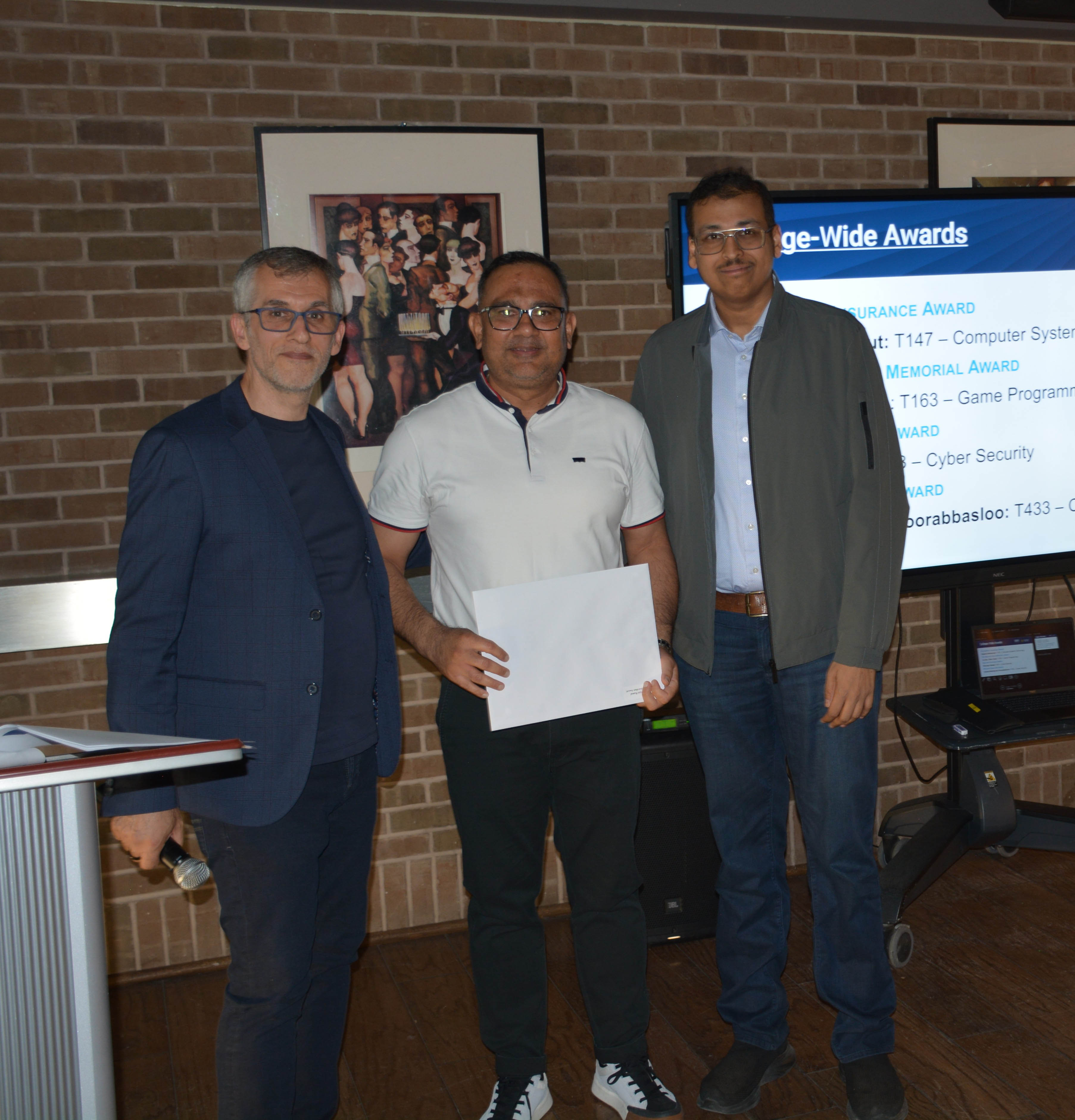 Milind Bhargava with Albert Danison, Associate Dean, School of Computer Technology, and a Mjolnir Award recipient at the 2026 George Brown Awards Ceremony.
